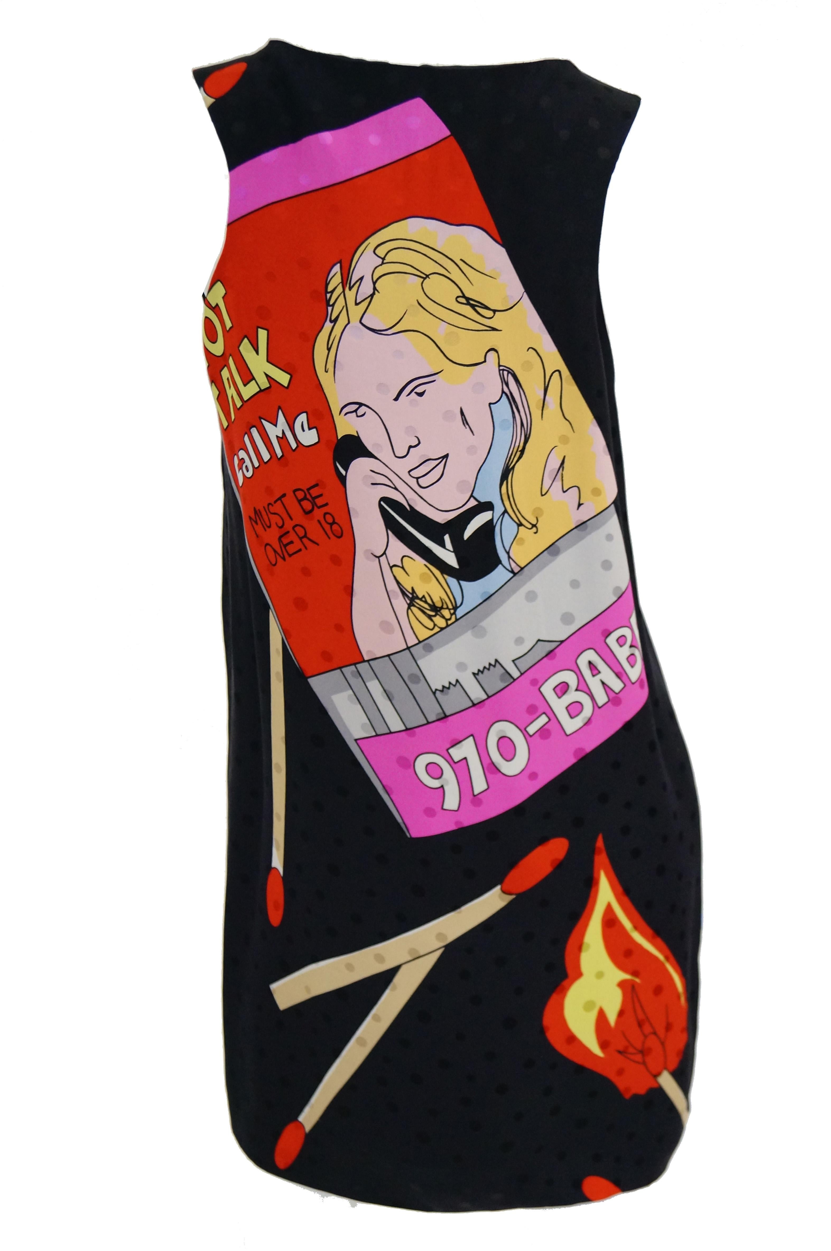 Amazing silk Pop Art shift dress by Nicole Miller! The dress is knee length, sleeveless, and has a wide neckline. The silk dress has polka dots woven in, and features various fun graphics on a black background, including matchbooks with dancers and
