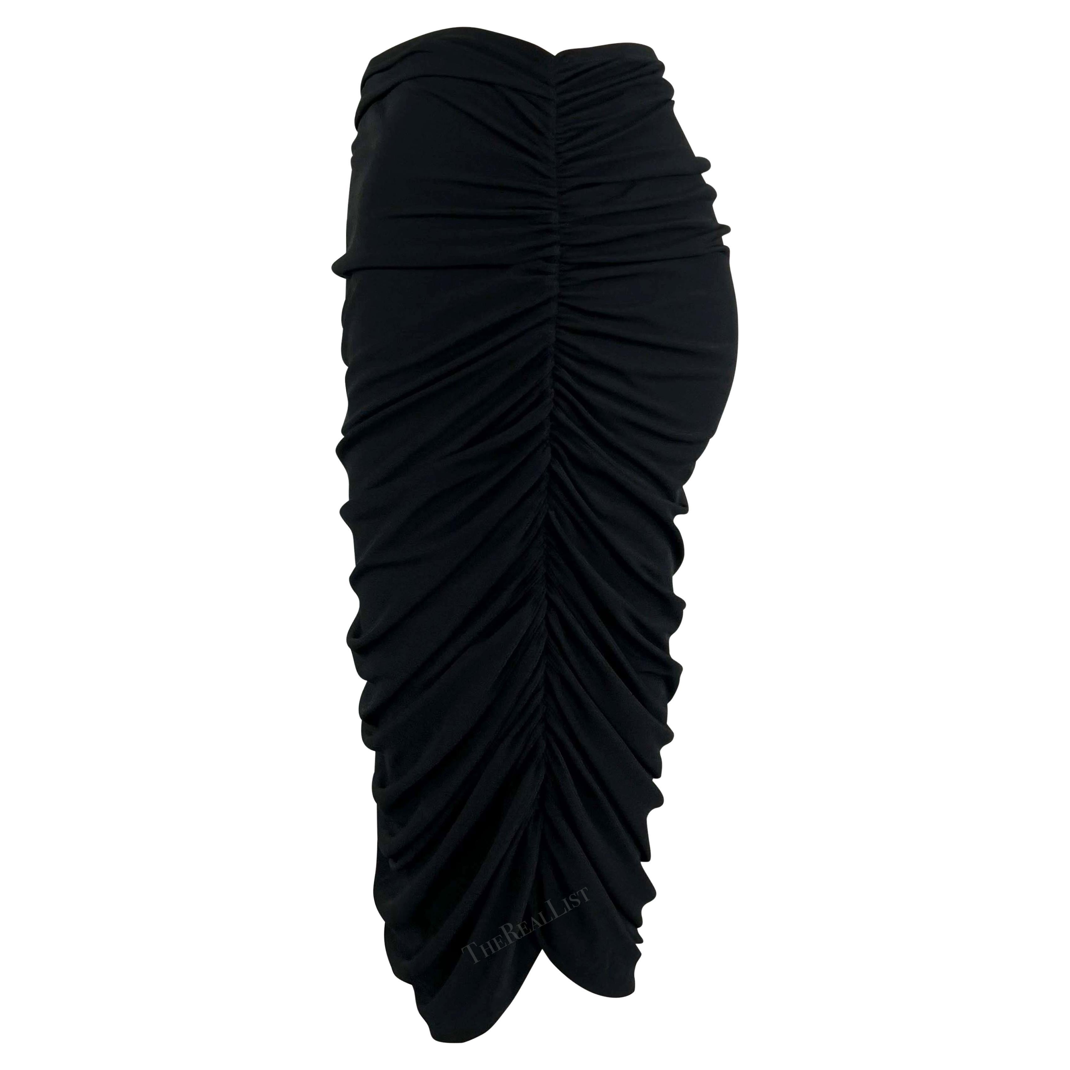 This fabulous black stretch Norma Kamali skirt from the 1990s features a snug fit and elegant ruching on both sides, creating a stylish draped effect on the front and back

Approximate measurements:
Size - L
Waistband to hem: 
Waist: 26” - 32”
Hips: