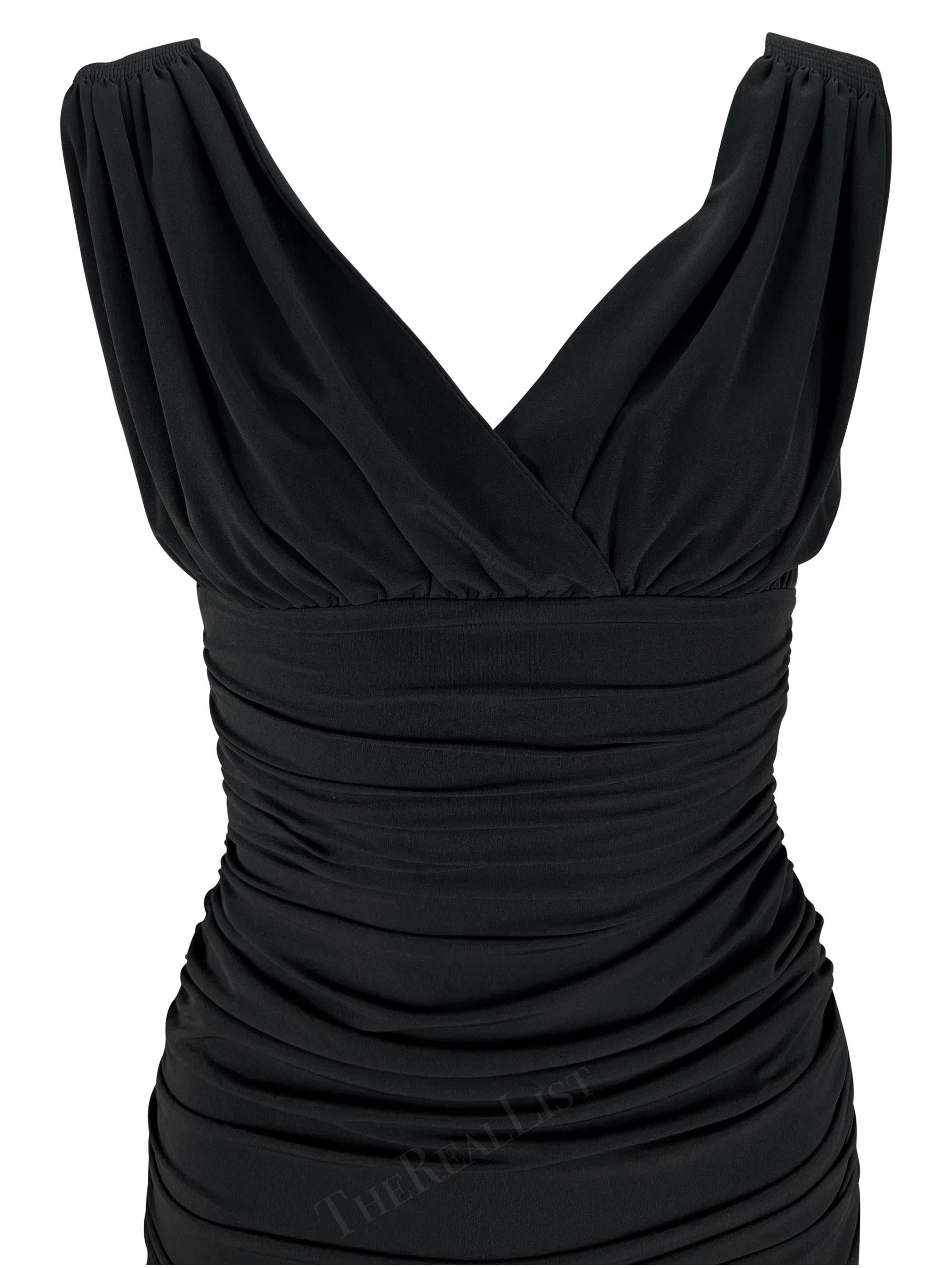 Presenting a stunning black Norma Kamali slinky gown. From the 1990s, this off-the-shoulder wiggle gown is covered in stretchy ruching throughout. Sleek, sexy, and form-fitting this Norma Kamali ankle-length gown features a v-neckline is the perfect