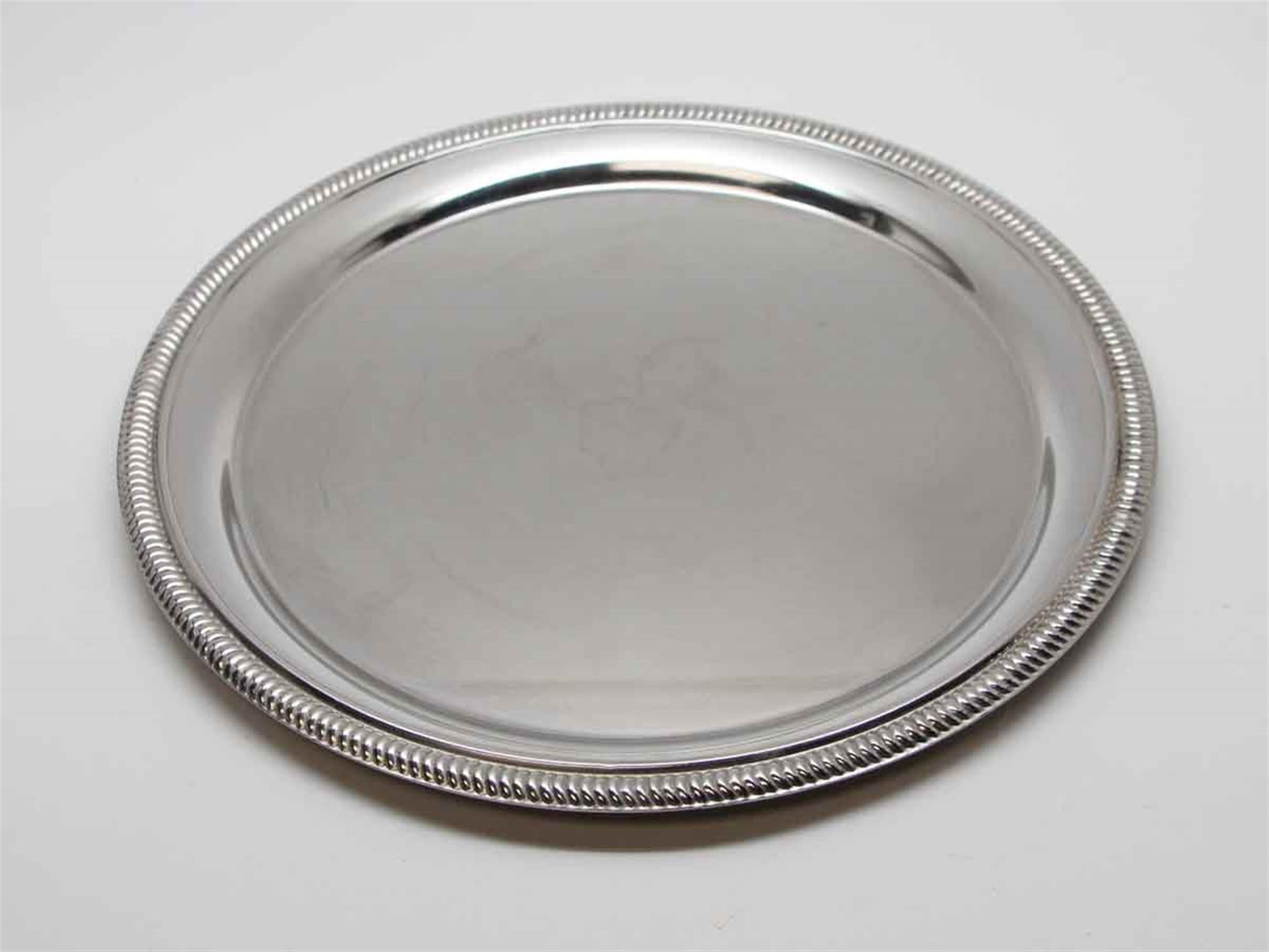 Round brass serving tray with a decorative edge from the 1990s NYC Waldorf Astoria. Waldorf Astoria authenticity card included with your purchase. Priced each. Measures: 10 in. Small quantity available at time of posting. Please inquire. Priced
