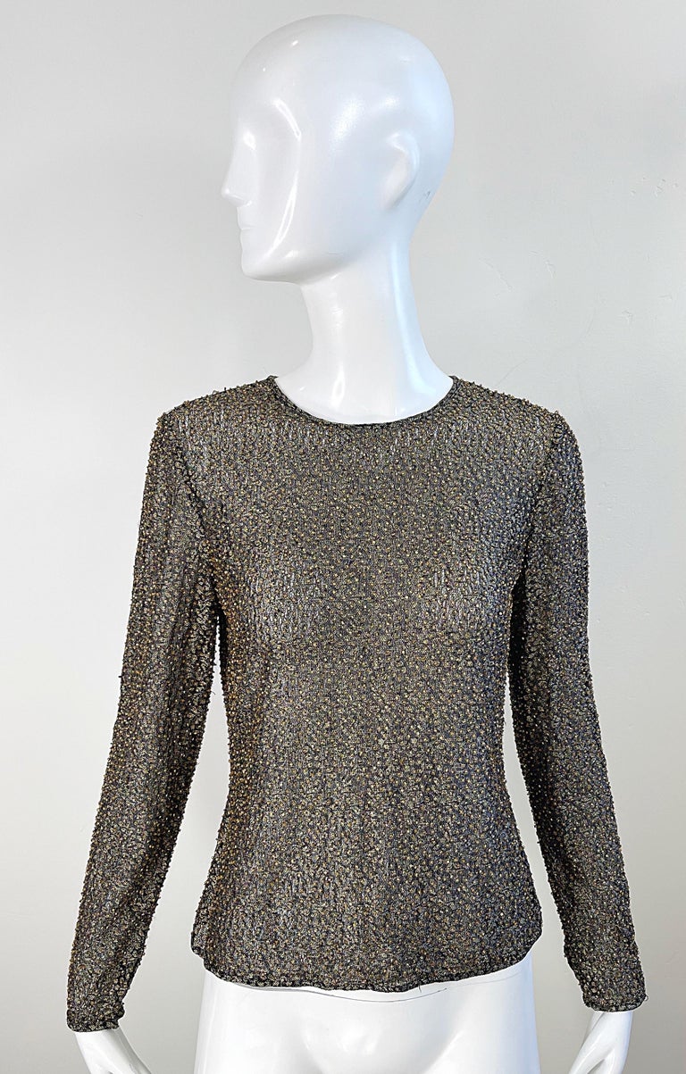Beautiful vintage 90s OLEG CASSINI semi sheer long sleeve blouse ! Luxurious soft fabric consists of Metallic ( 50 % ), Nylon ( 35% ), and Lycra ( 15% ). Thousands of metallic gold and bronze hand-sewn seed beads throughout. Button closure at top