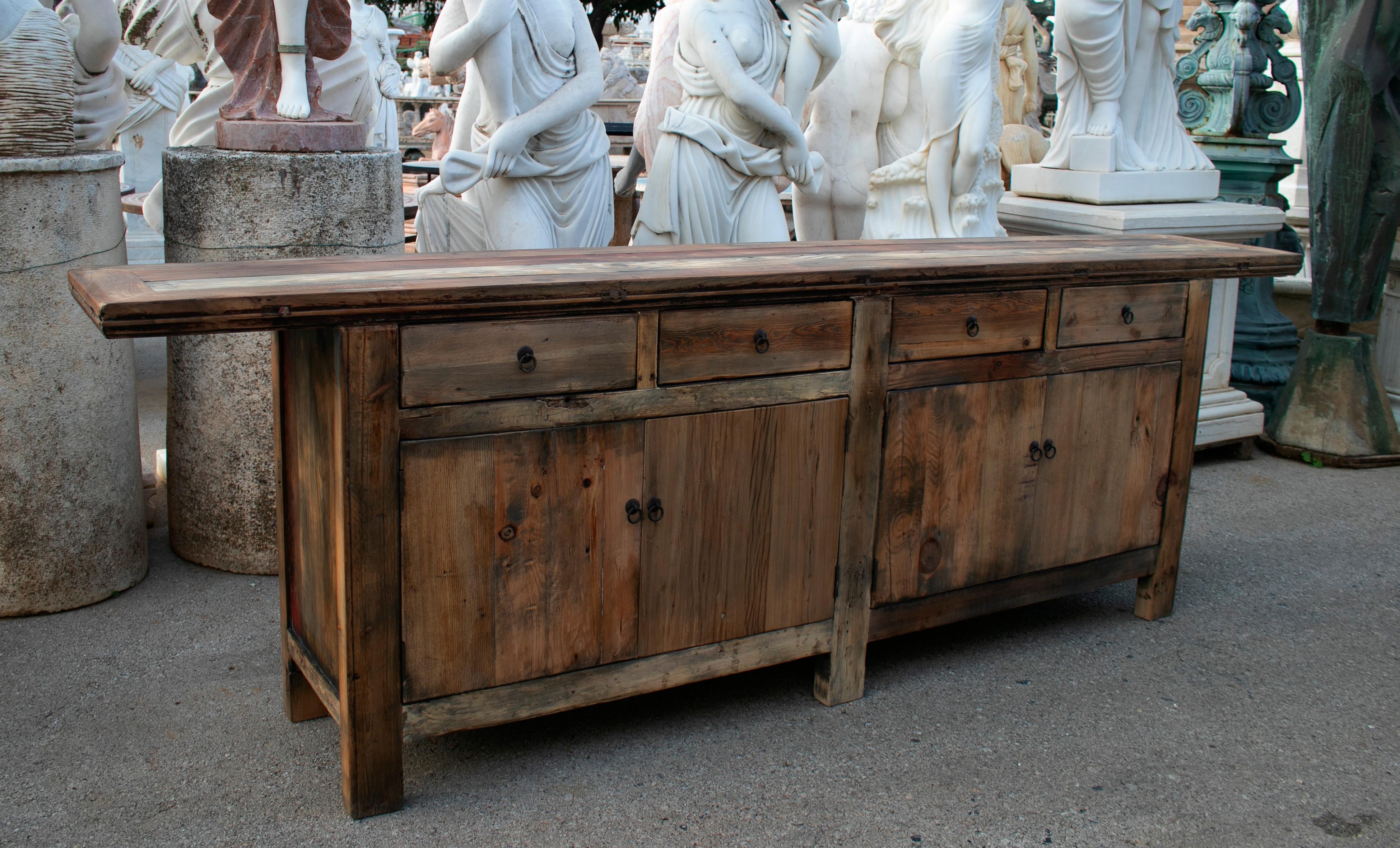 1990s Oriental four drawer and four door natural finish wooden console.