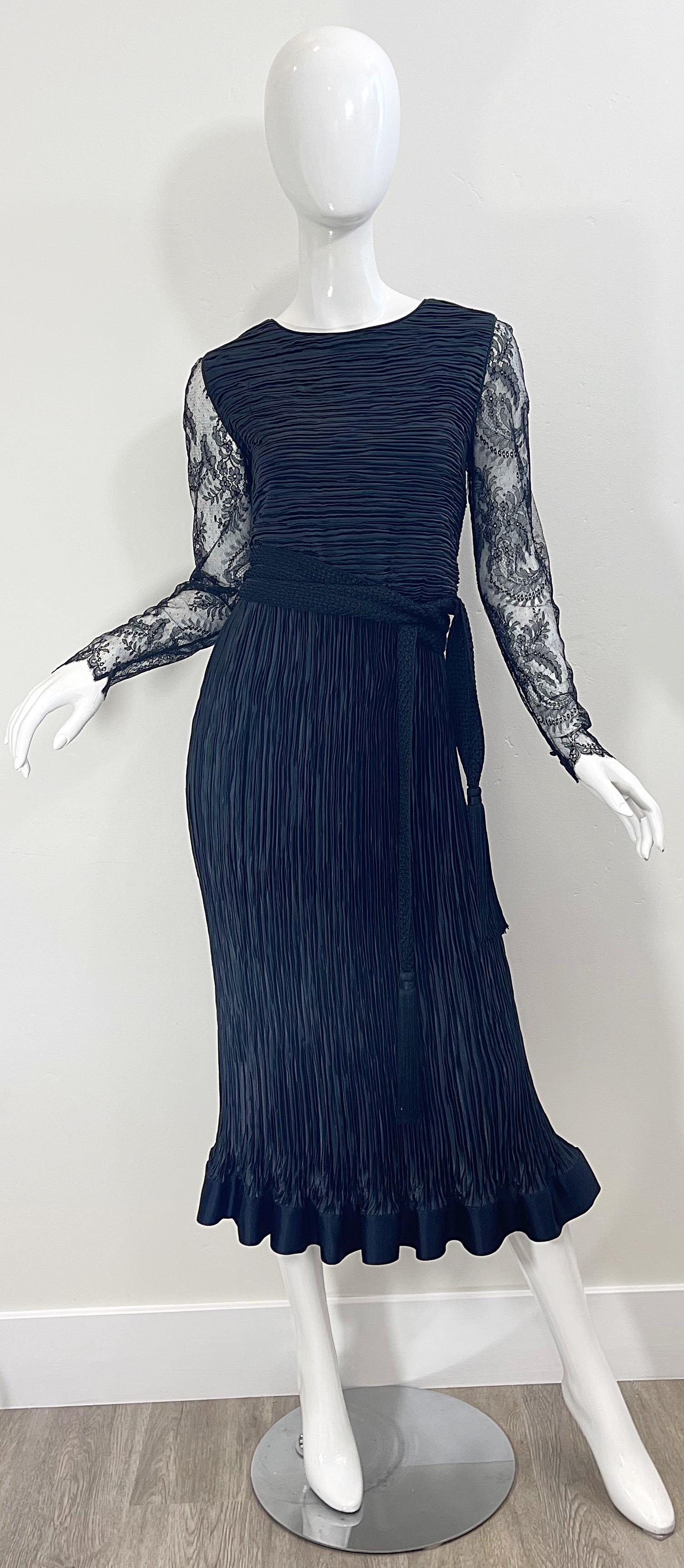 Beautiful 1990s OSCAR DE LA RENTA for Saks 5th Avenue black fortuny pleated chantilly French lace long sleeve dress ! Features a flattering pleated body with sheer lace sleeves, which have buttons at each cuff. Matching tassel belt has fringe at