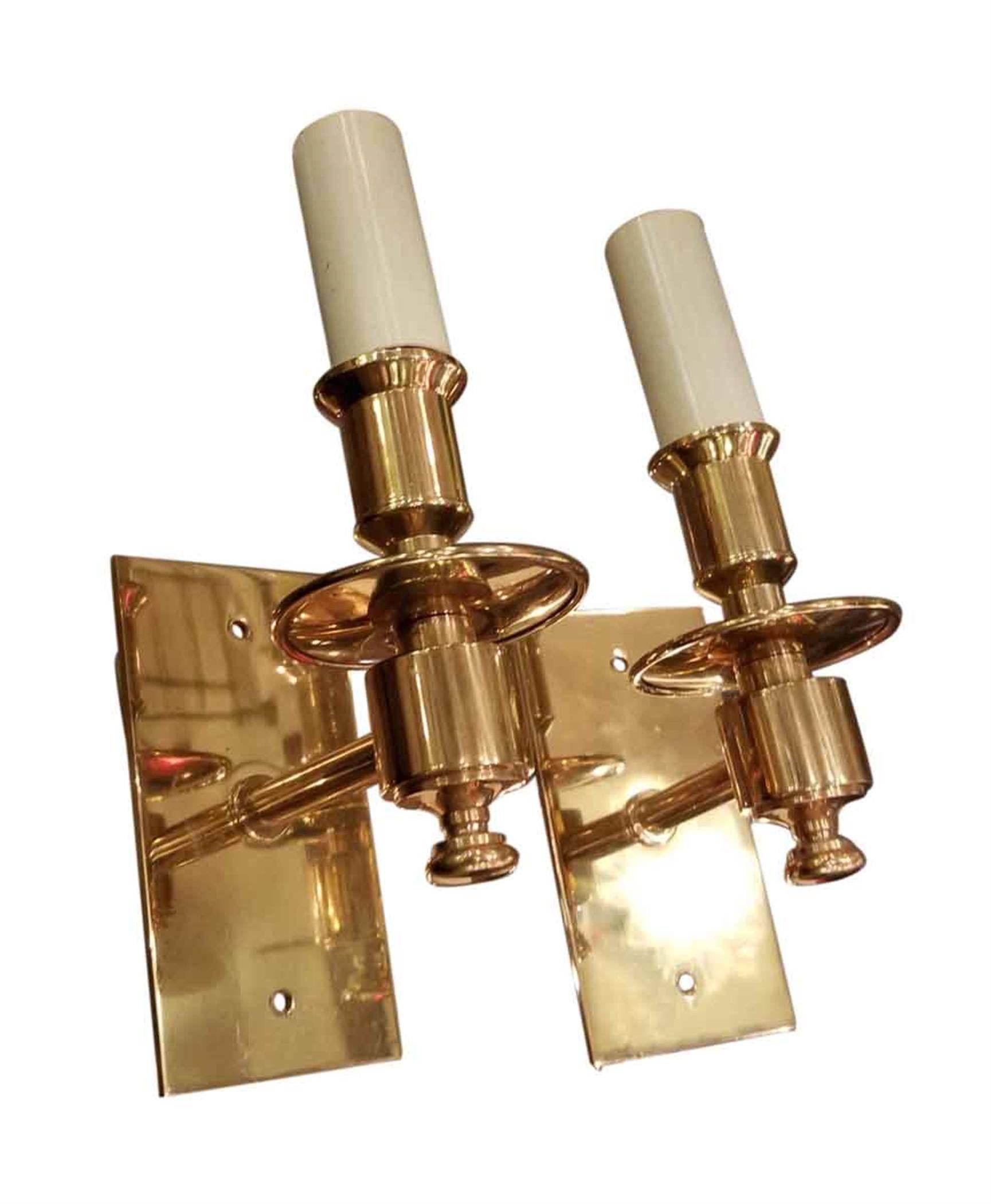 1990s pair of contemporary quality brass one arm candle sconces. These can be seen at our Broadway location on the upper west side in Manhattan.