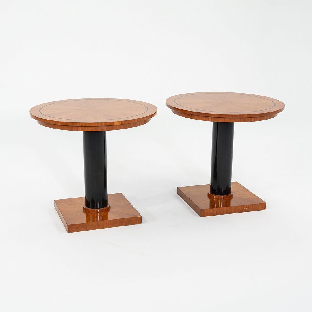 This is a pair of tall side / end tables designed by Michael Graves for Arkitektura and Craftwood Products in 1990. These examples date to the 1990s, and were produced in Canada. The listed price includes the pair. They feature cherry wood tops and