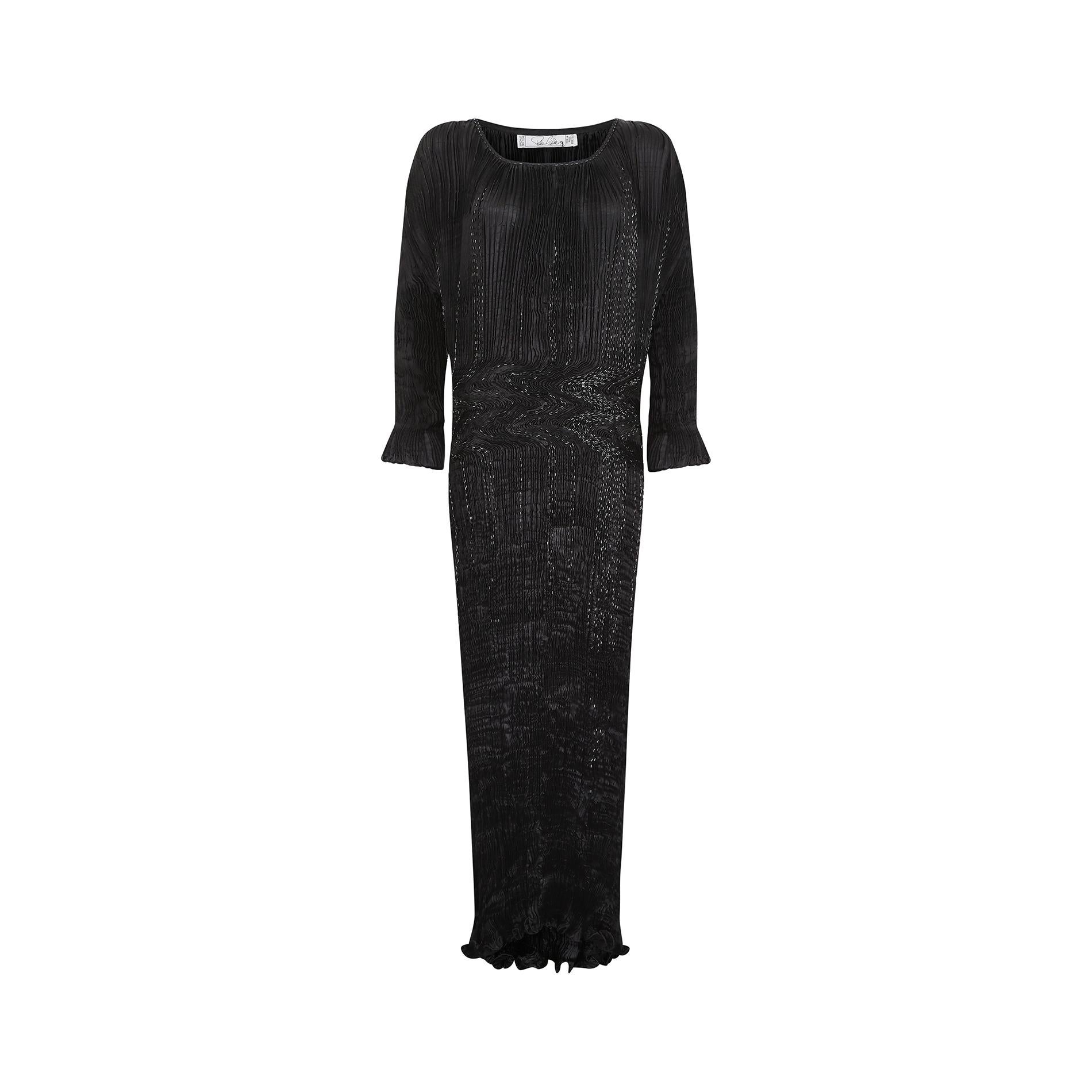 This is a truly elegant formal gown by renowned occasion wear designer Patricia Lester who has been designing costume and fashion with her husband Charles, for over 50 years.  Made from an inky black and very finely hand pleated silk which gives the
