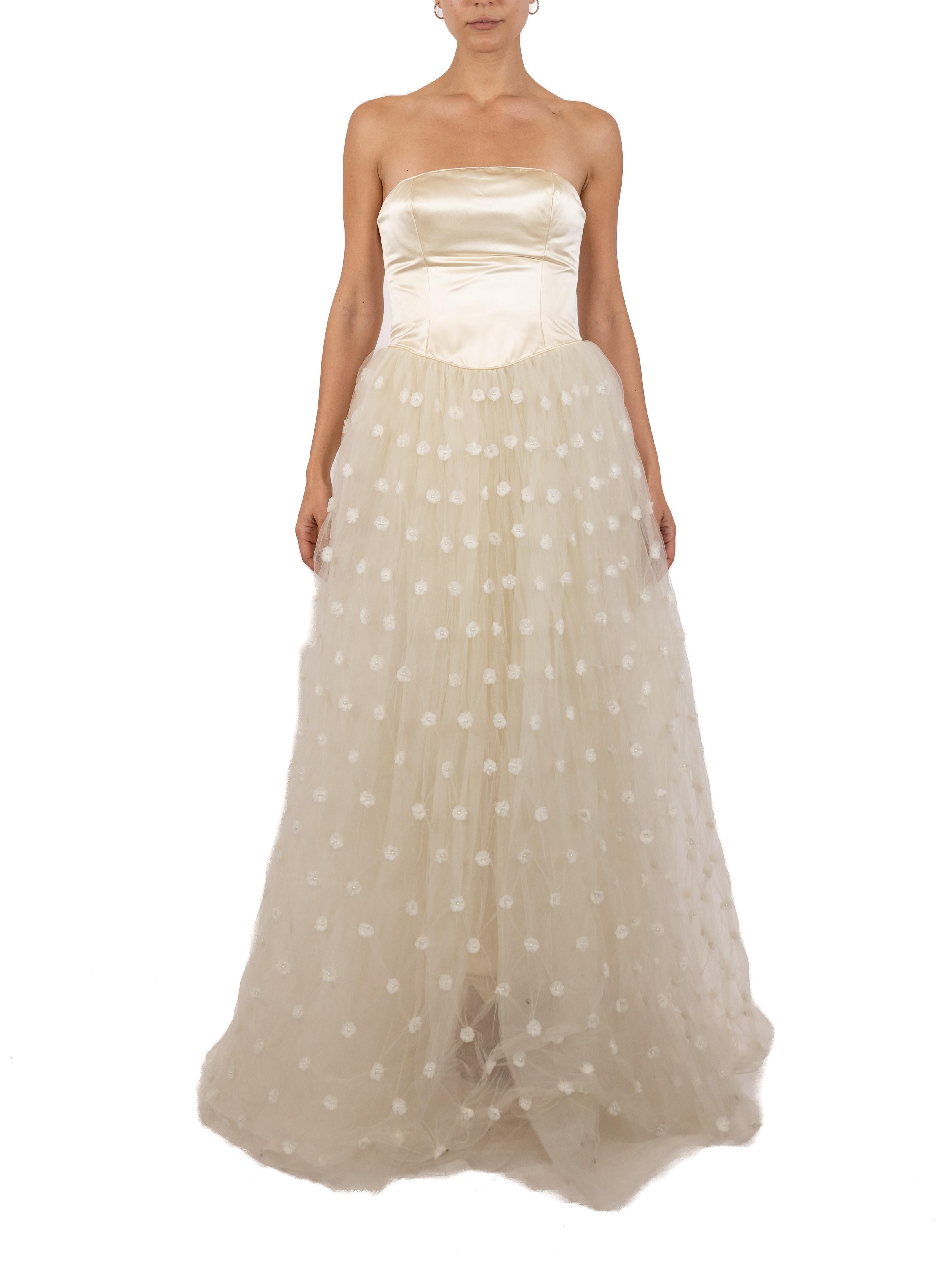 This gown retains no label, however the amount of hand-finishing points to Haute Couture or custom made quality, fully lined in silk. 1990S Pearl White Strapless Silk Duchess Satin Gown With Floral Covered Tulle Skirt 