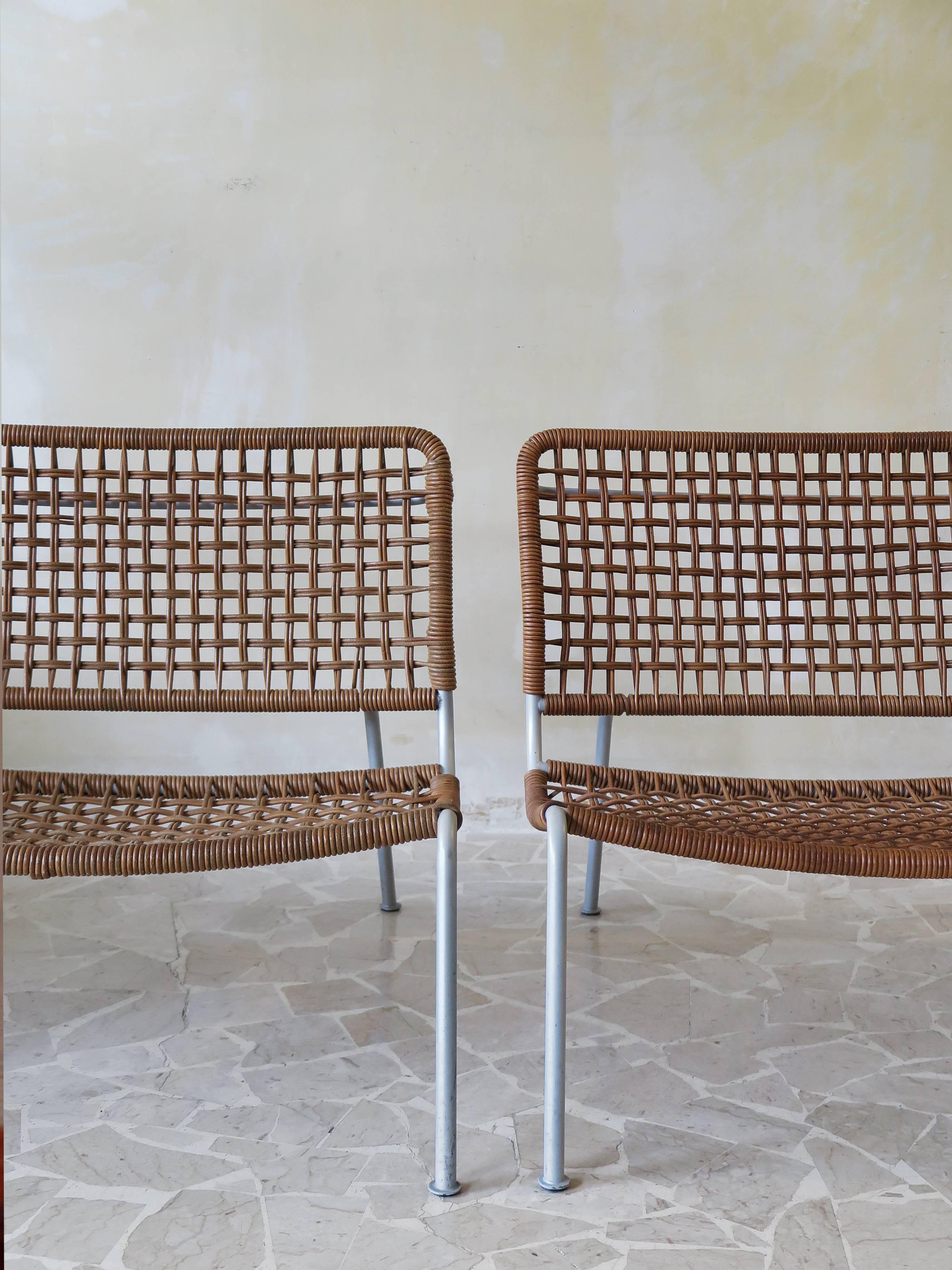 Couple of modern and contemporary armchairs designed by Piero Lissoni for Living Divani in 1995, supporting structure in steel painted with epoxy powders, leather stringing.
