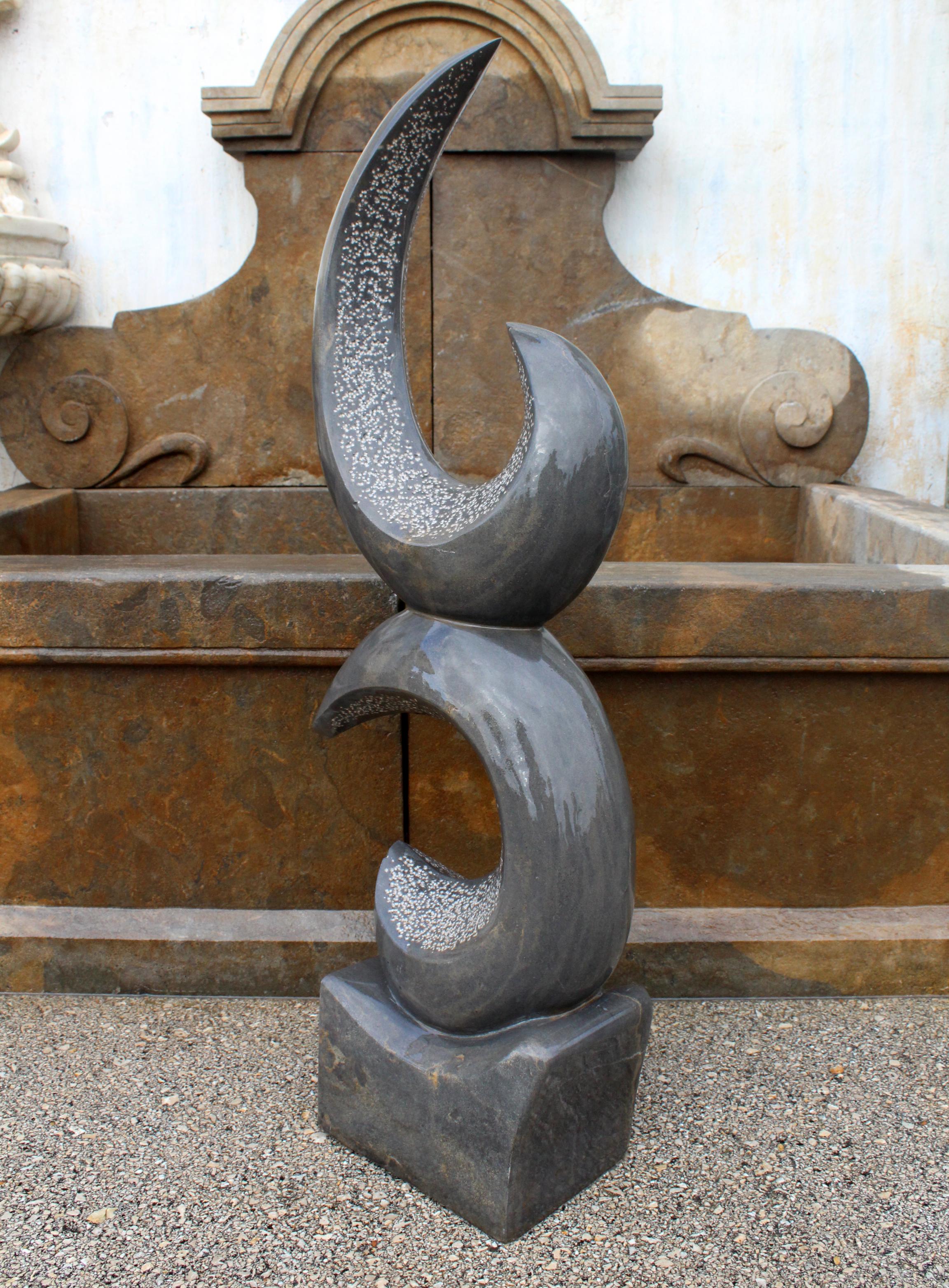 1990s modern abstract sculpture hand carved in pure Belgian black marble, where the interior of the half moon shapes has been bush hammered to create a contrast with the polished exterior.
 