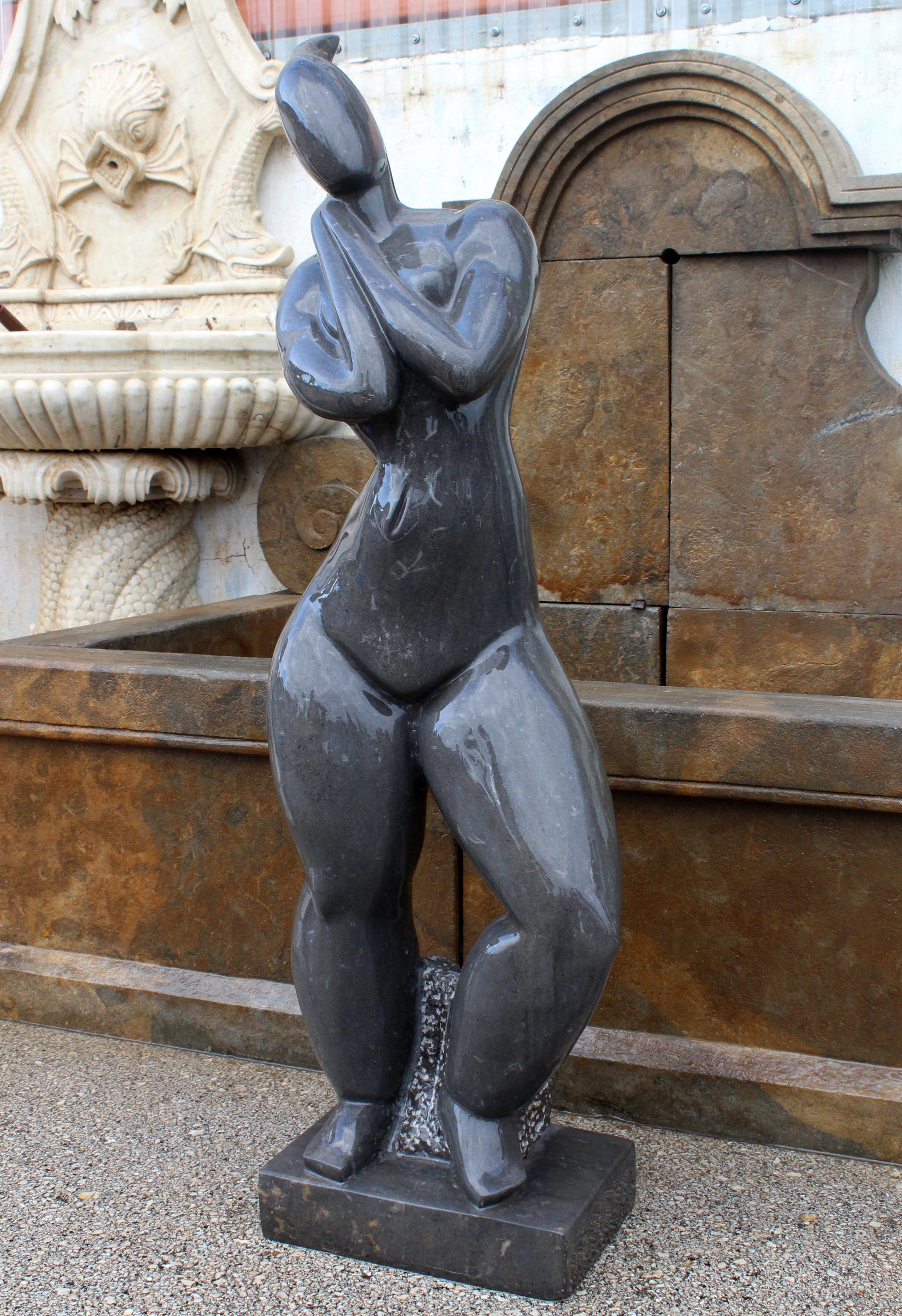 1990s polished modern figurative woman sculpture hand carved in pure Belgian black marble.
 