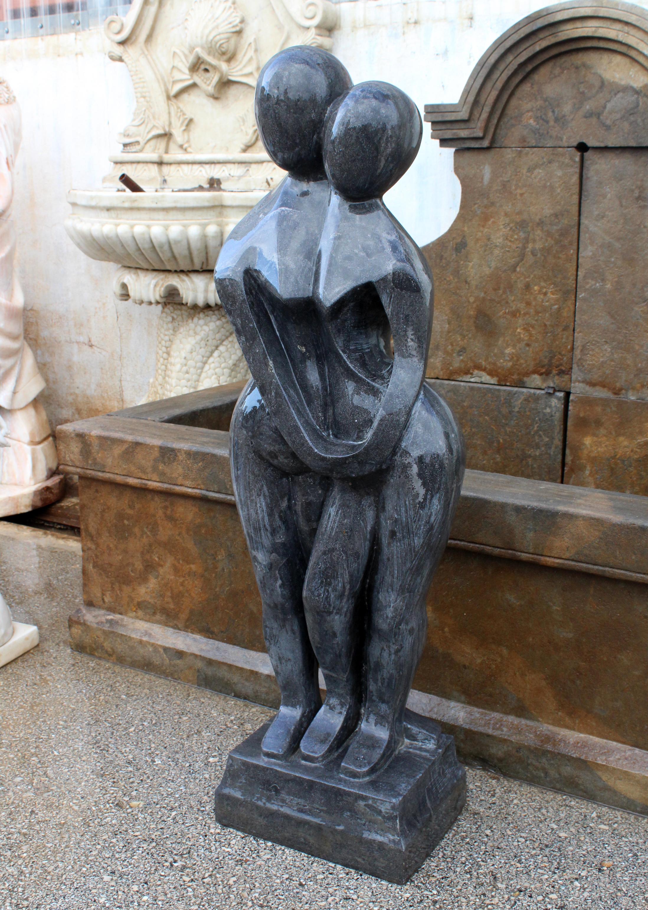 1990s polished modern figurative man and woman sculpture hand carved in pure Belgian black marble.
 