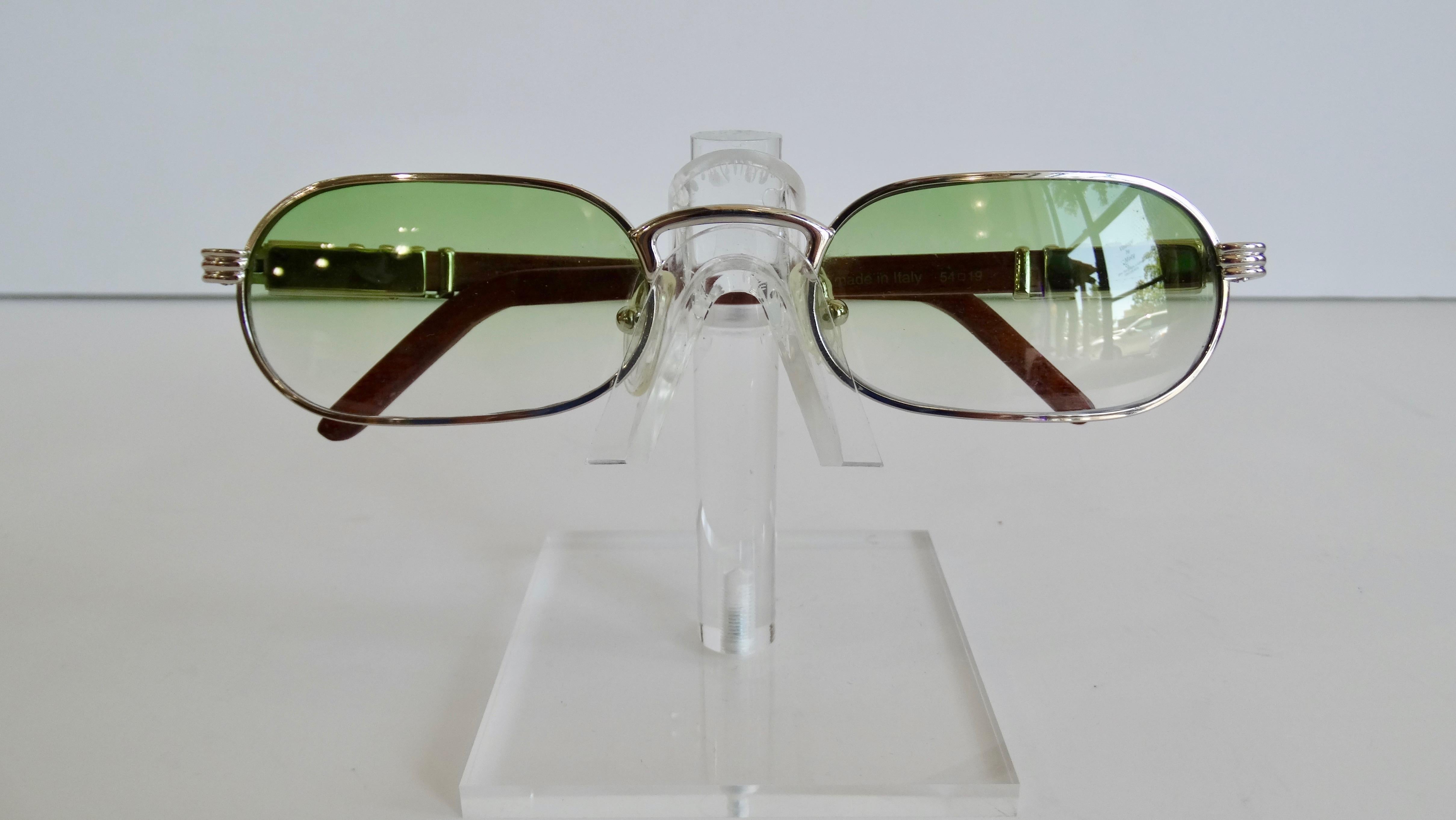 The Perfect Shades For The Summer Sun! Circa 1990s, these Porta Romana skinny oval sunglasses feature a green ombre lens and silver hardware. The silver hardware resting on the dark cherry wood stained arms features subtle horizontal and vertical
