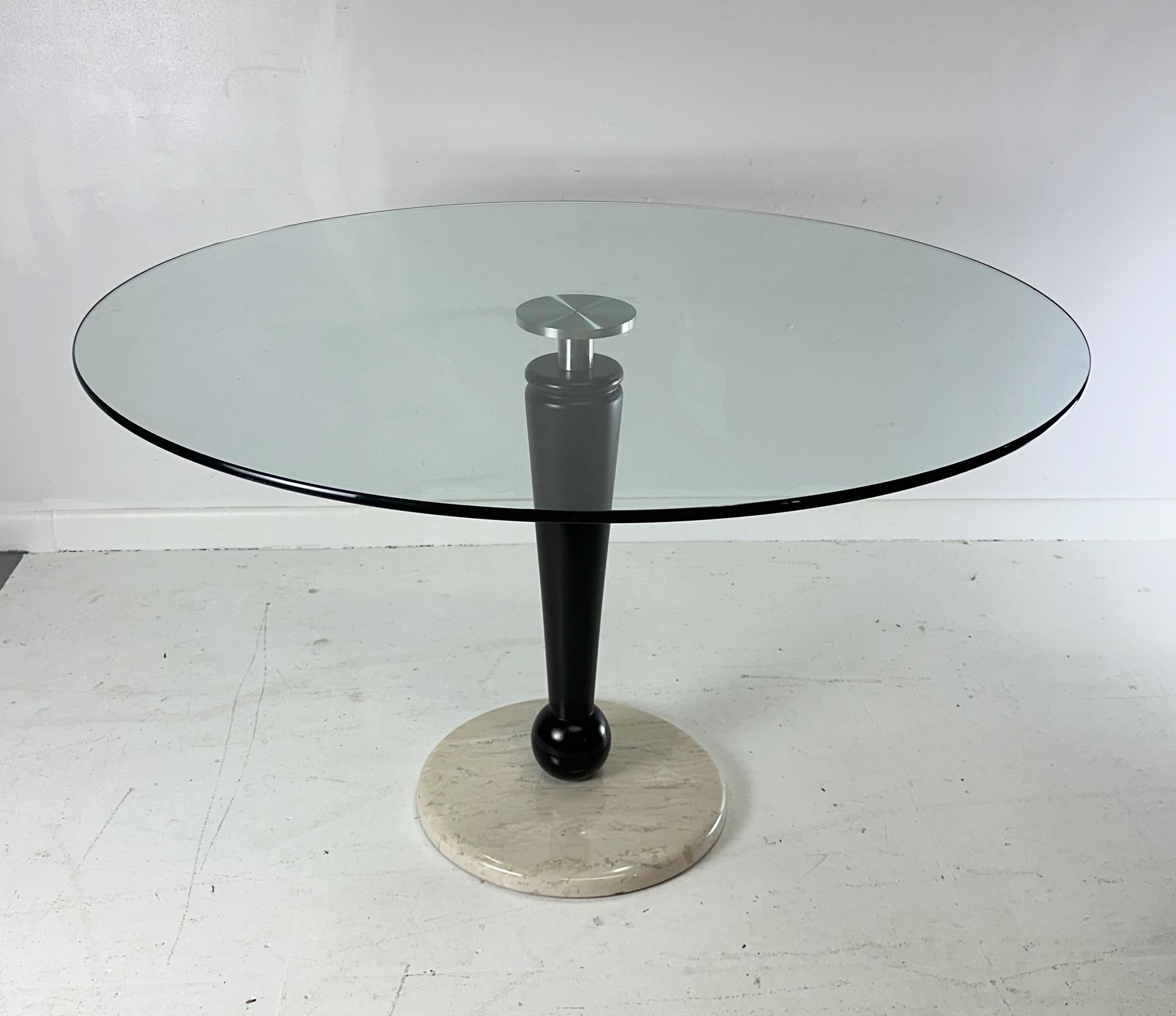This 1990s Post Modern table by Kaiser Newman is perfect for any center hall or breakfast room. With its sleek design and quality craftsmanship, it will add a touch of elegance to any space. Made with the highest standards utilizing glass, wood,
