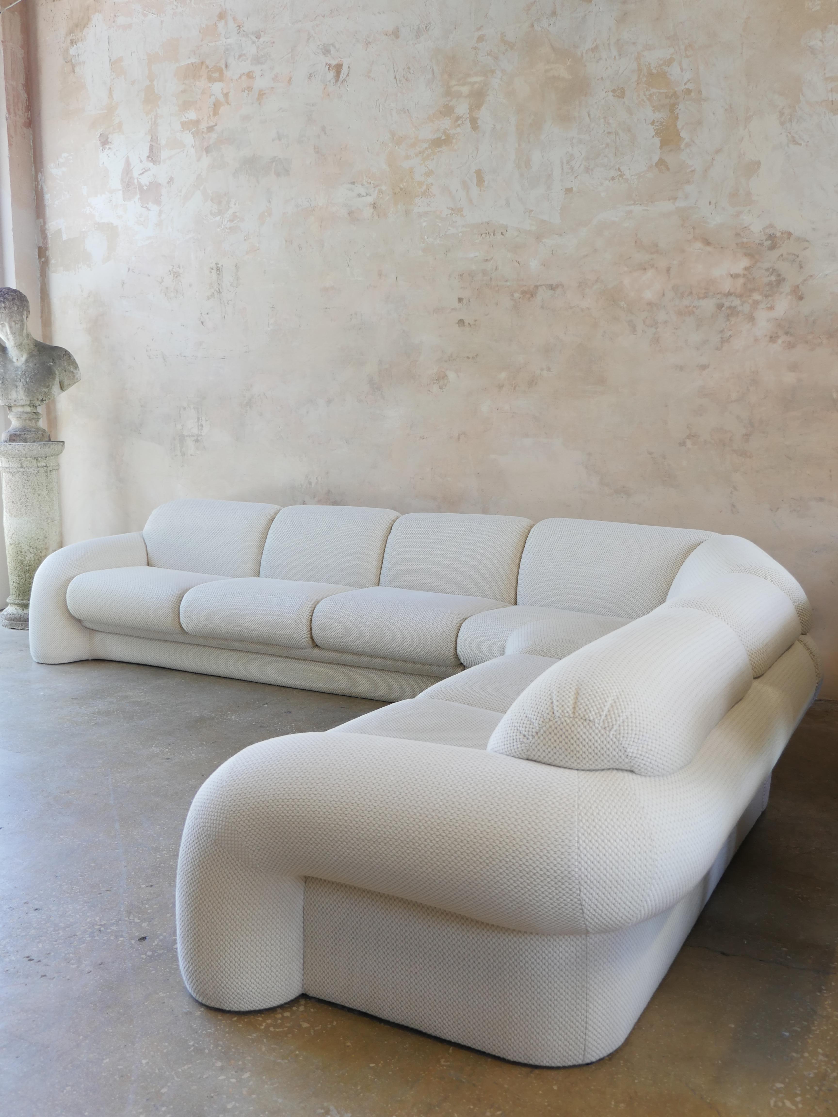 Monumental 1990s three-piece sectional sofa by Preview Furniture (commissioned by Judith Norman), with cylindrical chubby arms that curve throughout the back of the entire sofa. This breathtaking vintage sofa contains its original off-white,