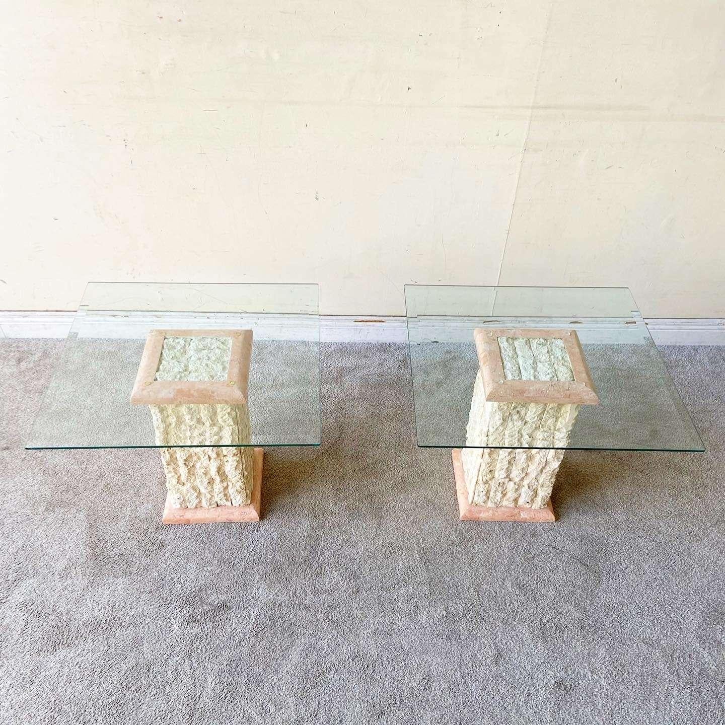 Incredible pair of vintage Postmodern beveled glass top side tables. Each feature a beige mactan and polished pink tessellated stone pedestal.
