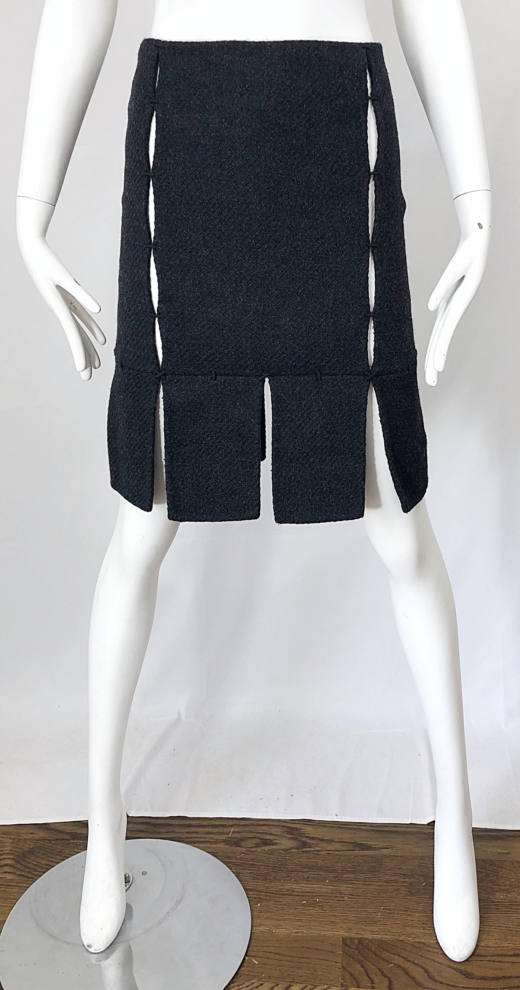 Rare late 90s PRADA charcoal gray cut-out high waisted wool pencil skirt! Features panels of wool stitched together to reveal just the right amount of skin. Chic car wash hem. Hidden zipper up the side with hook-and-eye closure. Can easily be