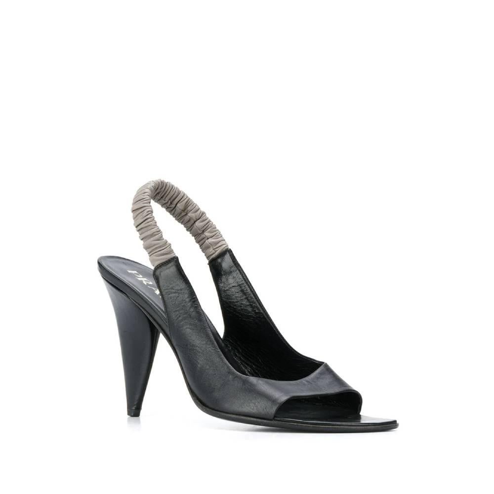 Prada open shoes in black leather and grey elastic strap on the back. Logoed insole in black leather and leather heel.

The product has small spots as shown in the pictures.

Years: 90s

Made in Italy

Size: 40 IT

Heels: 11 cm
Insole length: 26,5