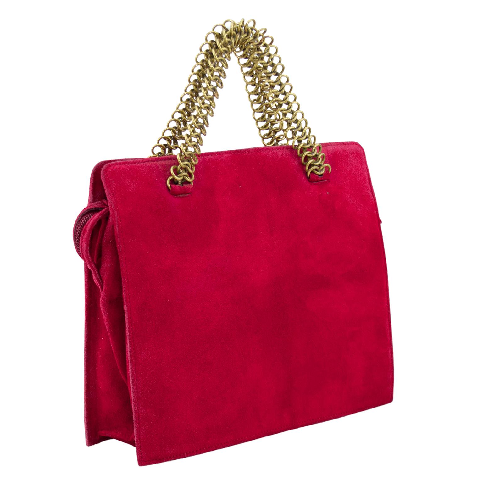 Prada square hand bag from the 1990s. Red suede with gold chain link top handles. Suede can read red or magenta pink depending on the lighting. Zipper closure across the top with suede pull tab and Prada blind stamp on front. Black all over branded