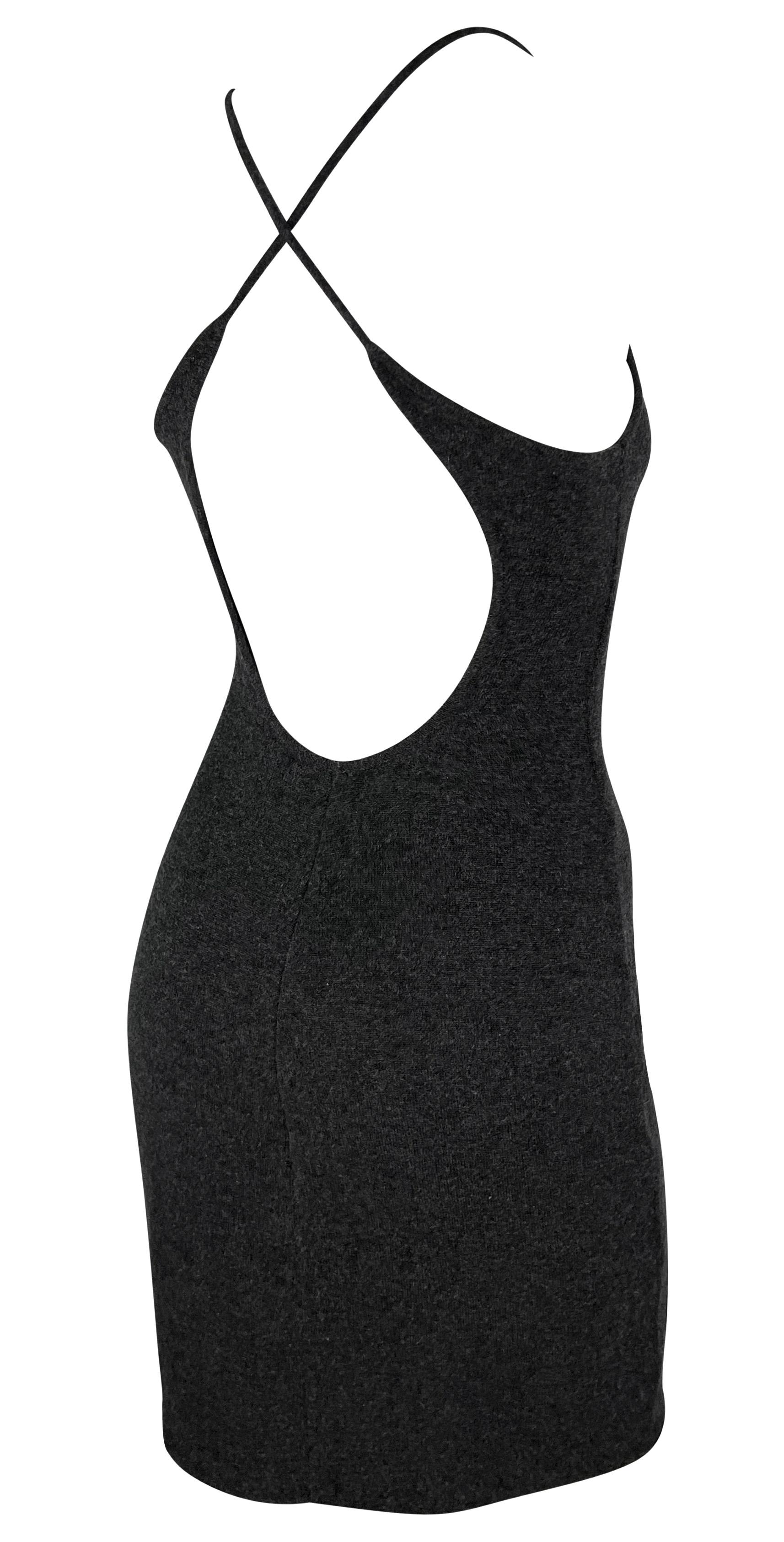 This dark grey knit Ralph Lauren purple label mini dress features a slip style constructed entirely of luxurious cashmere. The dress is complete with a scoop neckline and straps that cross over an exposed back. 

Approximate measurements:
Size -