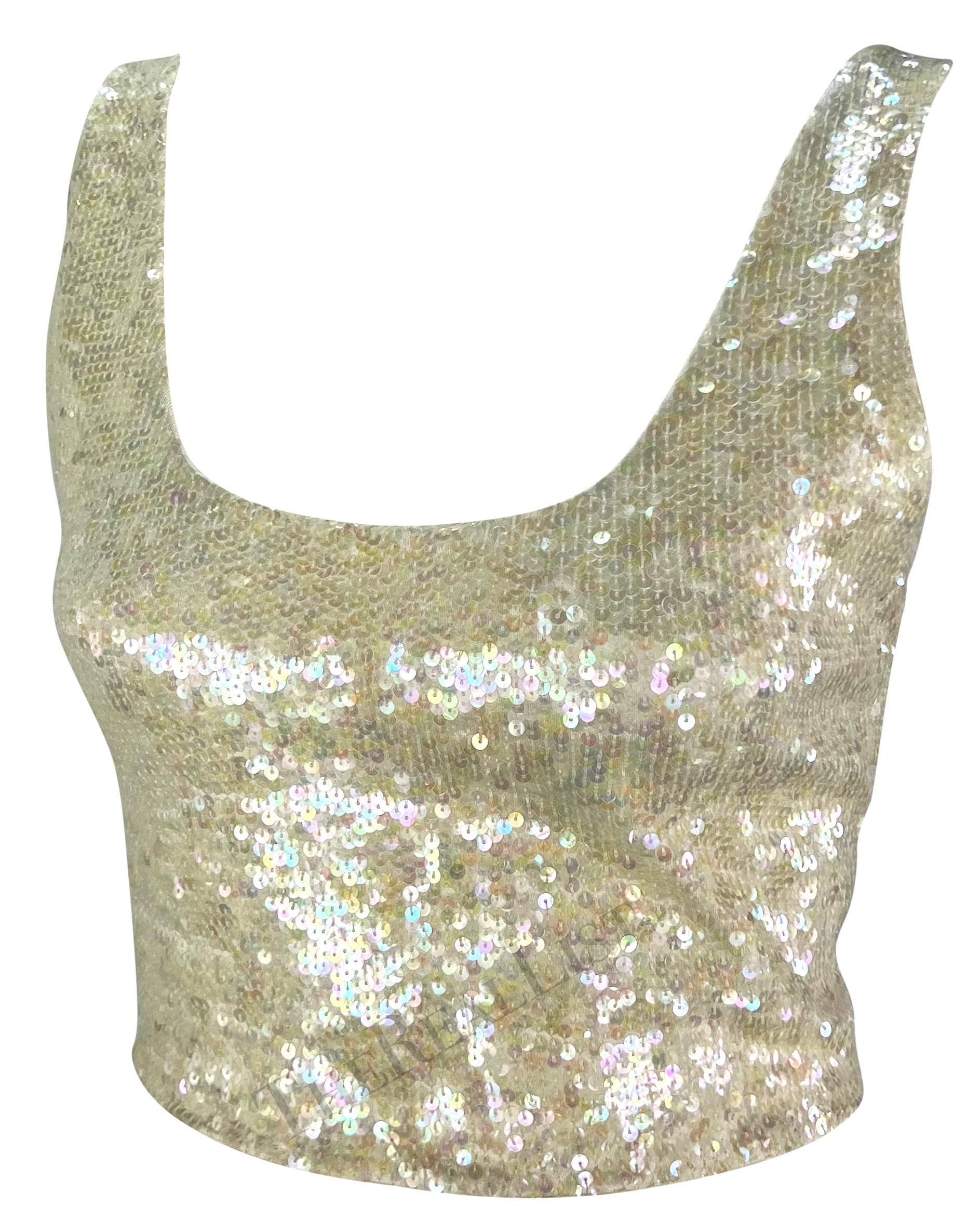 Presenting an exquisite off-white Ralph Lauren sequin crop tank top from the 1990s. This dazzling top features iridescent sequins, a scoop neckline, and a low scoop back, adding a touch of brilliance to its design. The perfect sparkly addition to