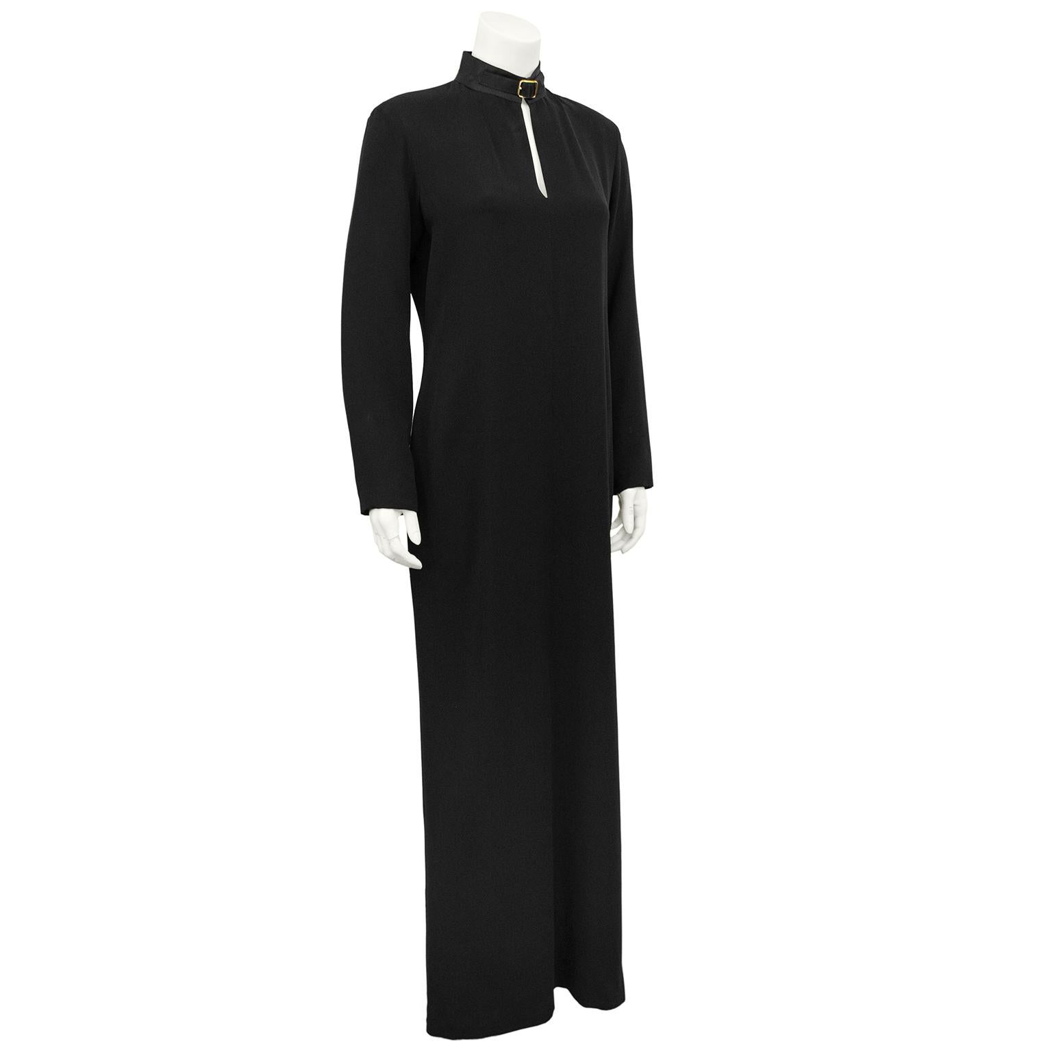 Sleek and stunning long sleeve black silk crepe Ralph Lauren Purple label gown from the 1990s. Subtly contrasting black satin high collar with gold tone buckle detail and long key hole cut out. The contrast of the silk crepe and satin gives the gown