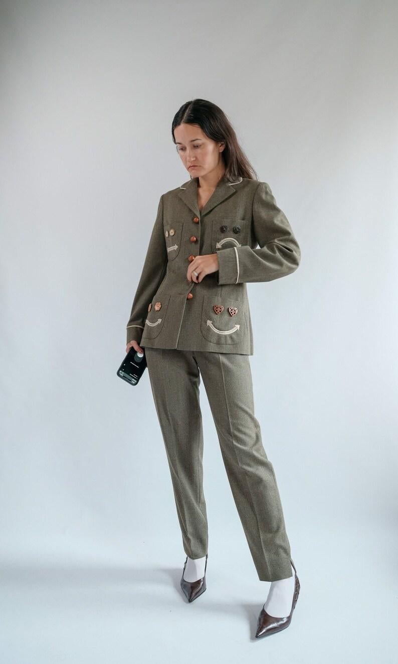 1990s Rare Archival Moschino Cheap and Chic Nuts About You Smiley Face Trouser Suit 
wow, no words for this one. Absolutely obsessed. 
Slim tailored high waisted trousers and matching tailored smiley faces with real hazelnut buttons. 
Exceptional