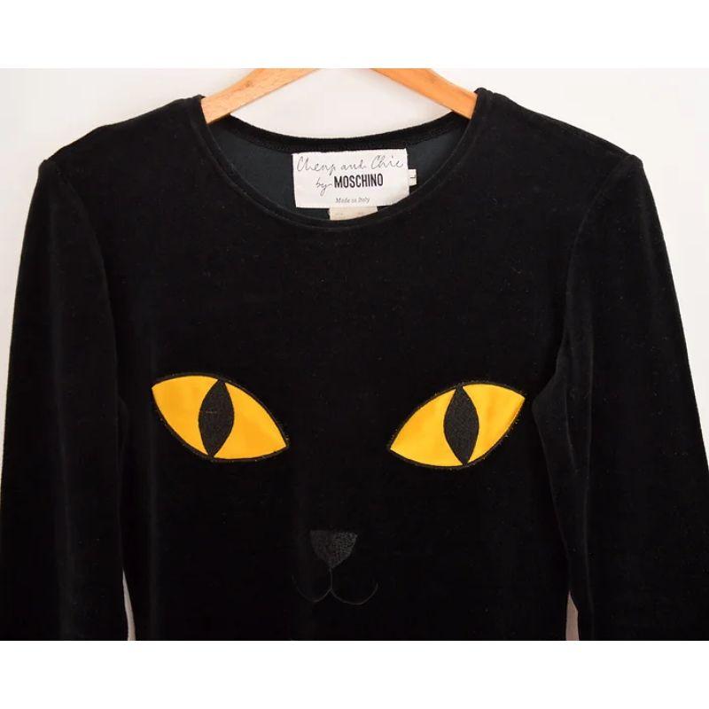 Rare Vintage early 1990's Moschino black velvet 'Cheap & Chic' label long sleeve top, featuring novelty Cat face appliqué to the front. 

MADE IN ITALY !

Features:
Long Sleeves
Rounded Neckline
Archive Piece
Trompe L'oeil embroideries

85% Cotton /
