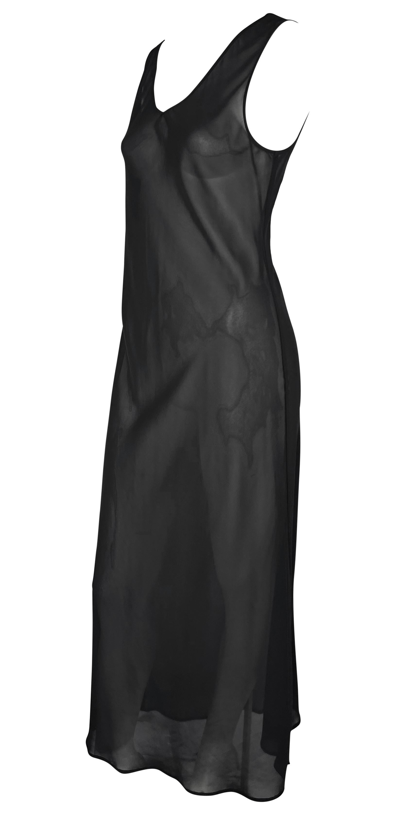 This alluring black slip gown by Ozbek from the 1990s is crafted entirely from sheer fabric. The sleeveless design features a flattering v-neckline and a nearly floor-length hem, making it a versatile and bold addition to any wardrobe.

Approximate