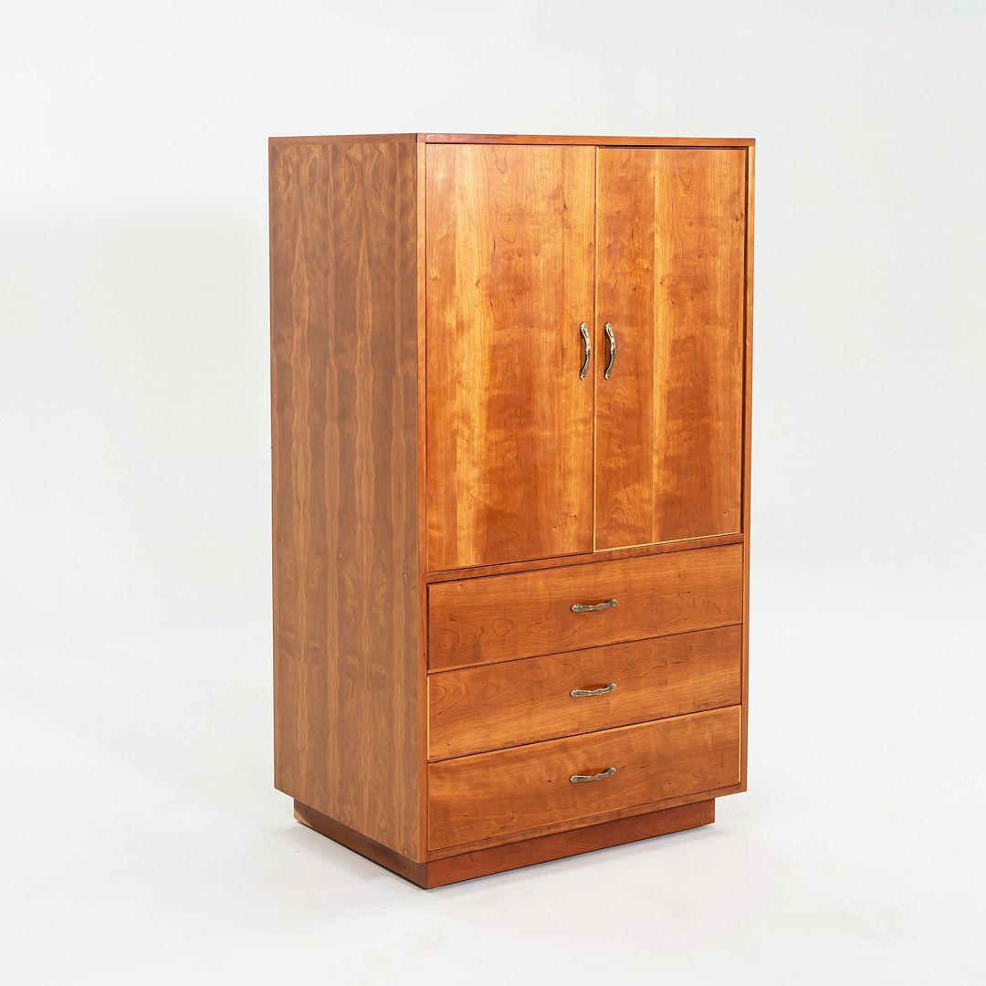 This is a Custom-Made Armoire in Cherry Wood, executed by renowned master woodworker Robert Lovett. Lovett was prevalent in the New Hope, Pennsylvania area, having worked under George Nakashima for ten years before founding his independent studio.