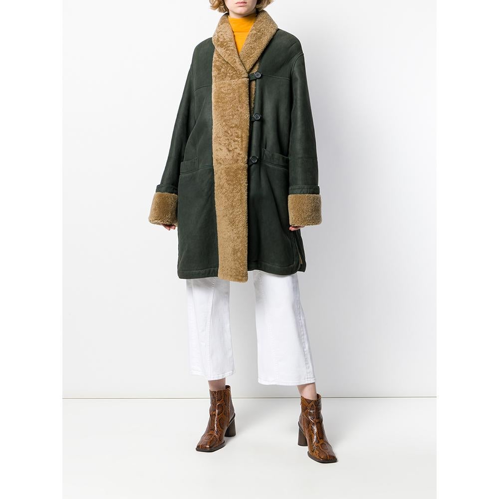 Romeo Gigli forest green sheepskin coat with beige fur. Featuring a front buttoning, long sleeves, two front pockets and central rear vent.

Years: 90s

Made in Italy

Size: 44 IT

Flat measurements
Height: 97 cm
Bust: 67 cm
Shoulders: 51