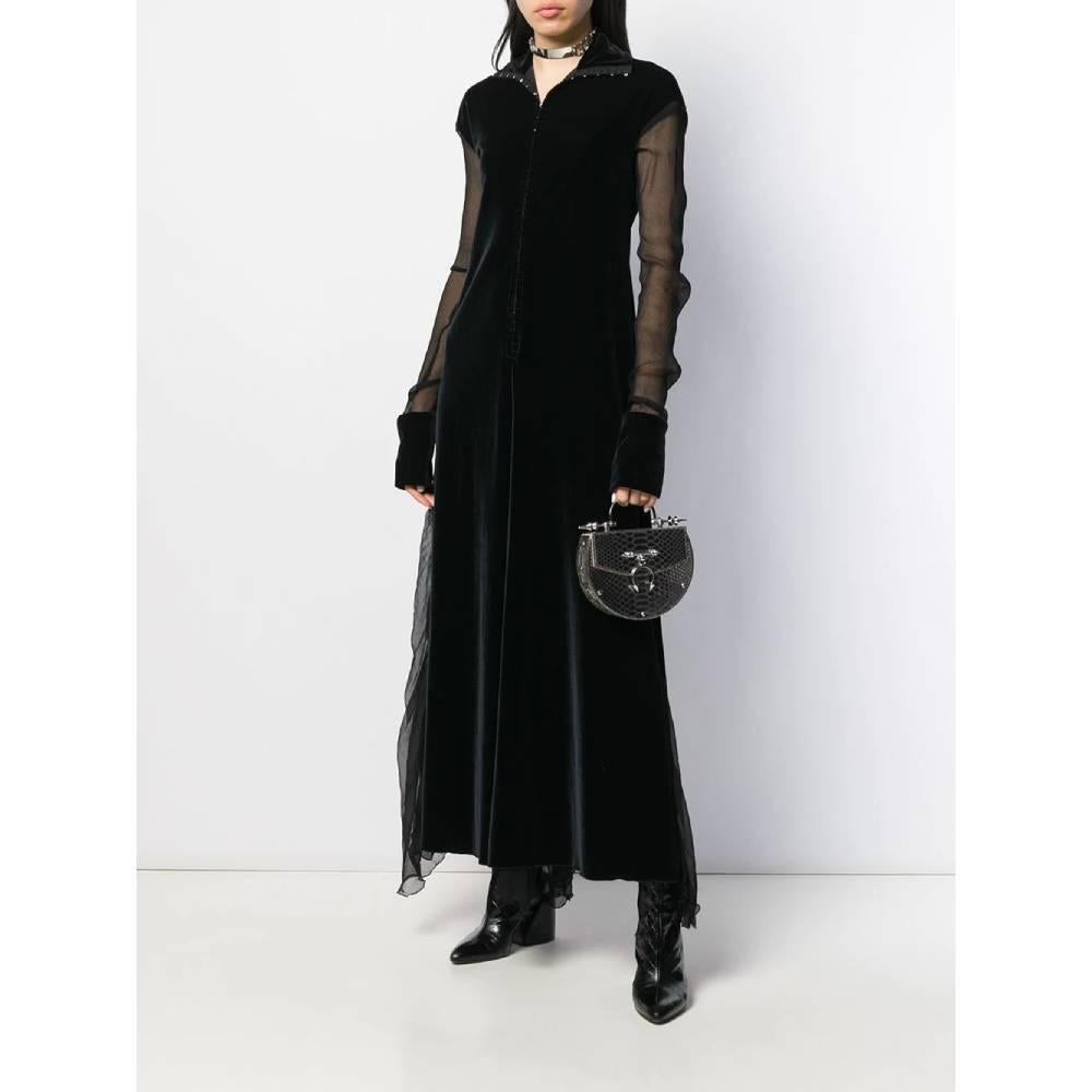 Romeo Gigli long dress in black velvet. Model with raised collar and invisible front hooks. Long sleeves in semitransparent fabric and inserts on the bottom of the skirt.
Years: 90s 

Made in Italy 

Size: 44 IT

Flat measurements 

Height: 141 cm