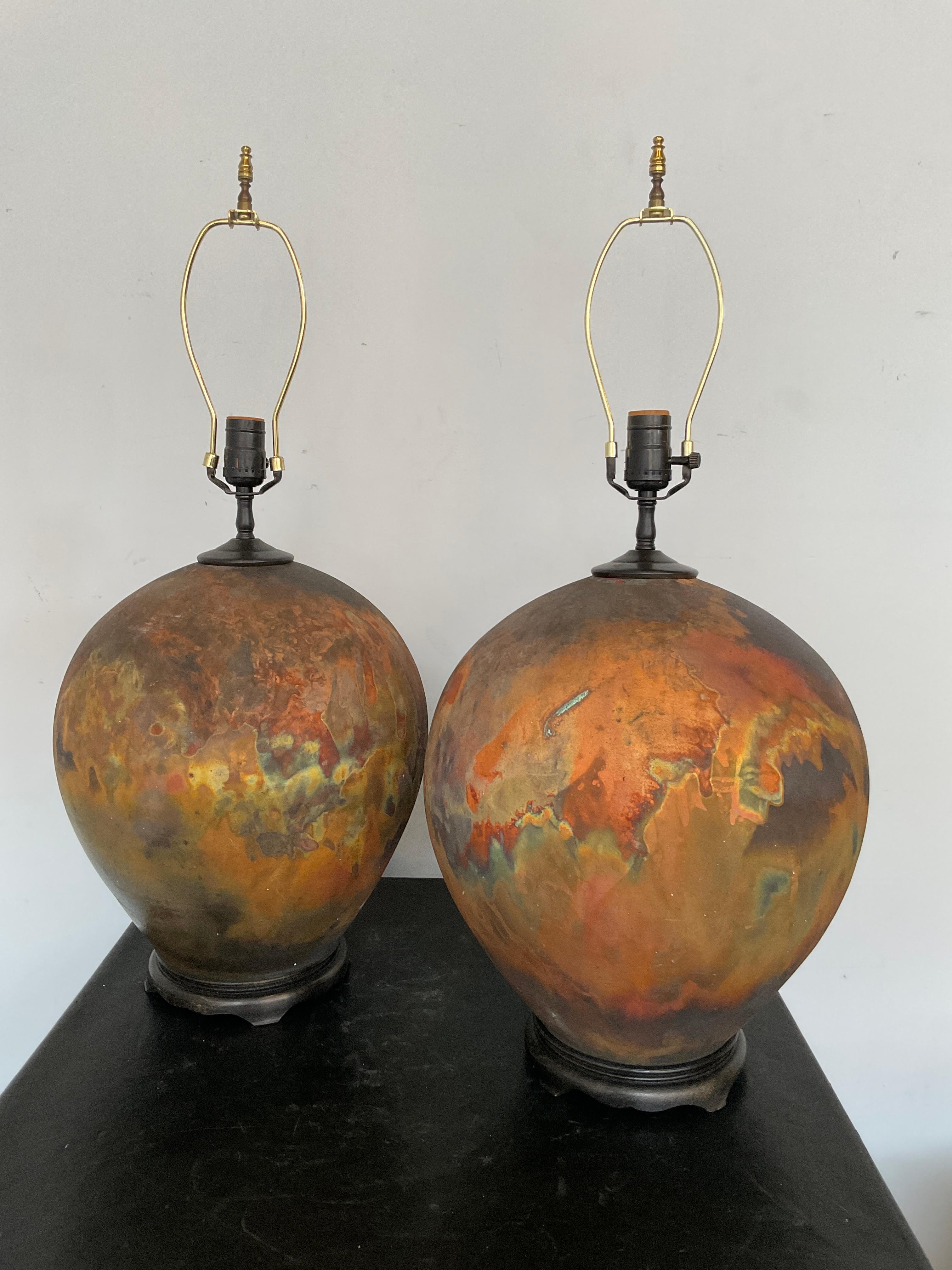 Pair of 1990s ceramic raku multi color lamps. The colors look like 
the ceramics were just taken out of the oven. Love the orange glow.