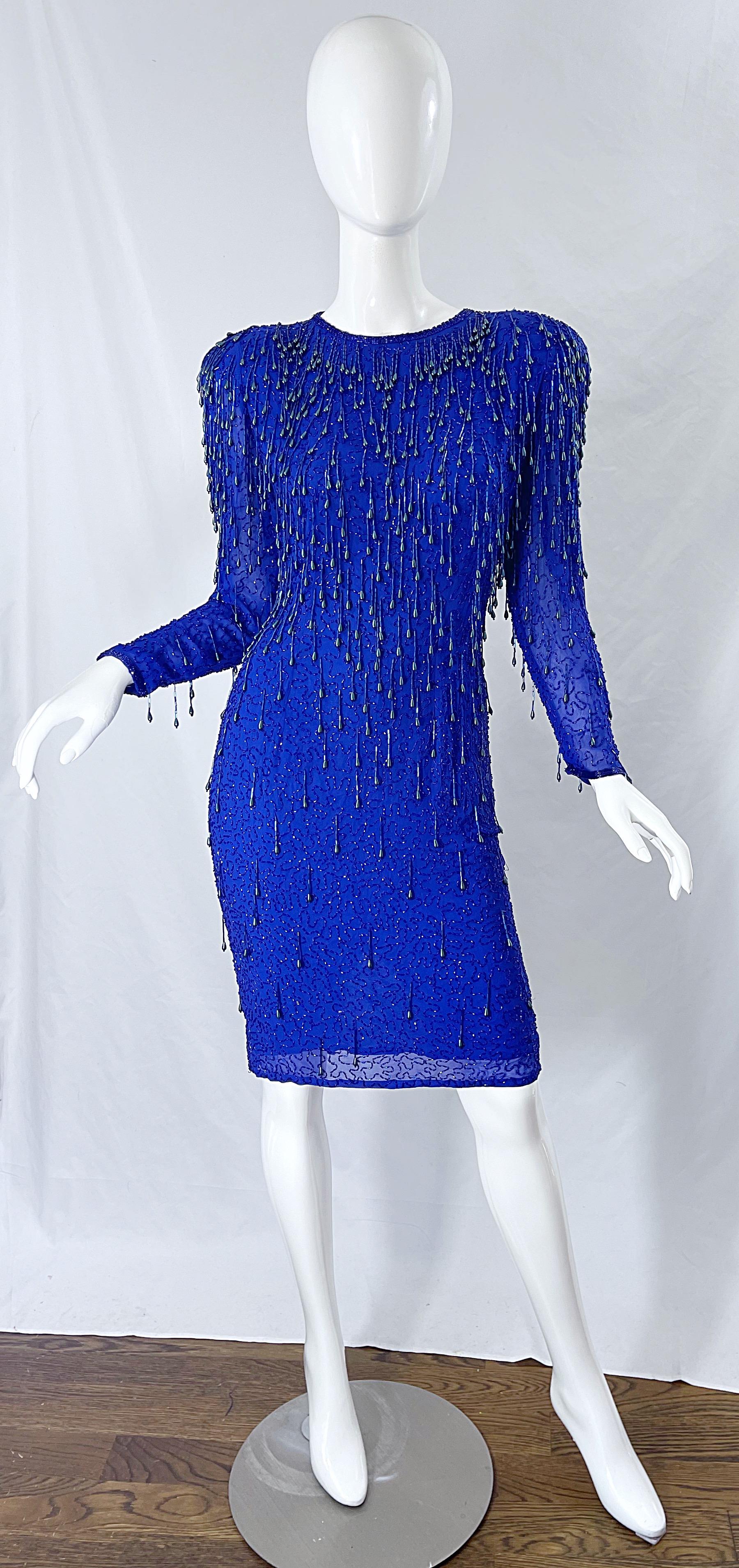 Amazing early 90s royal blue silk chiffon beaded sequin long sleeve dress ! Thousands of hand-sewn beads throughout look phenomenal on, especially while dancing. Built in shoulder pads add just the right amount of volume. Semi sheer sleeves have