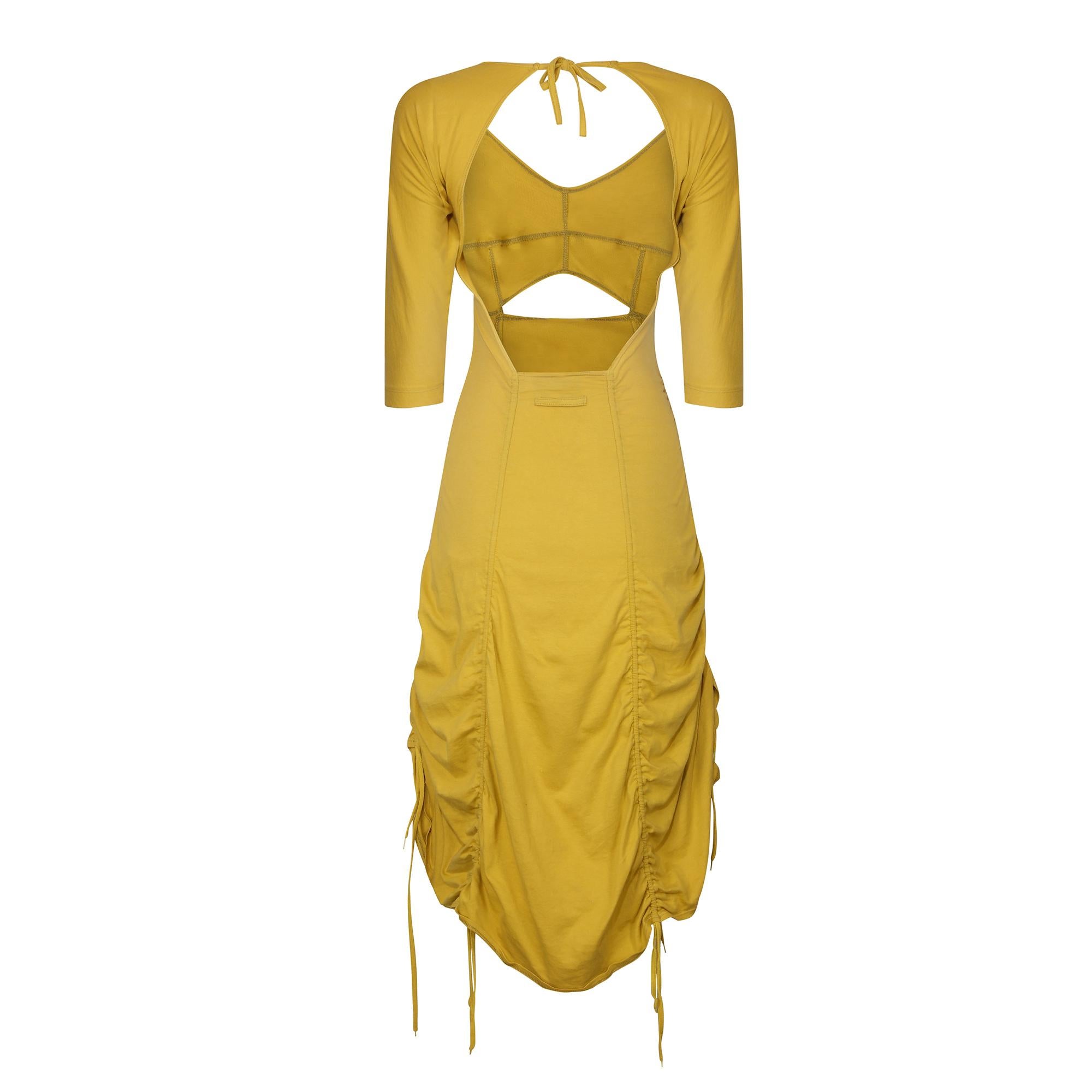 It is wonderful to be able to attribute this piece to a runway show and this dress is from the Jean Paul Gaultier ready to wear spring summer 1991 collection. It is made from a mustard yellow cotton stretch jersey with the ruched element of the