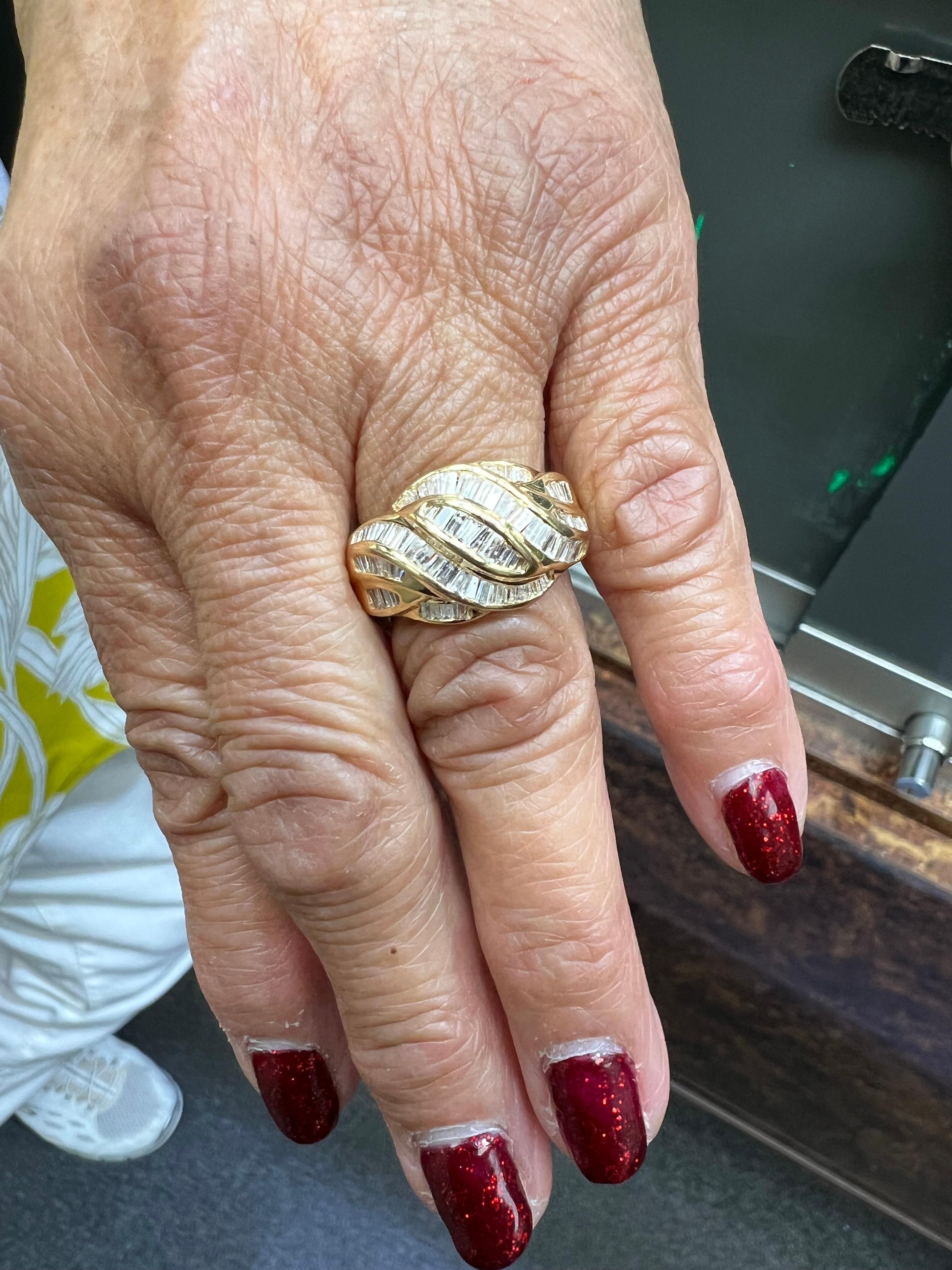 1990s Salt And Pepper Baguette Diamond Swirl Dome Yellow Gold Ring.

The Salt and Pepper Baguette Diamond Swirl Dome 14k Yellow Gold Ring from the 1990s is channel set with various graduated baguette cut diamonds.  The overall look is quite unique. 