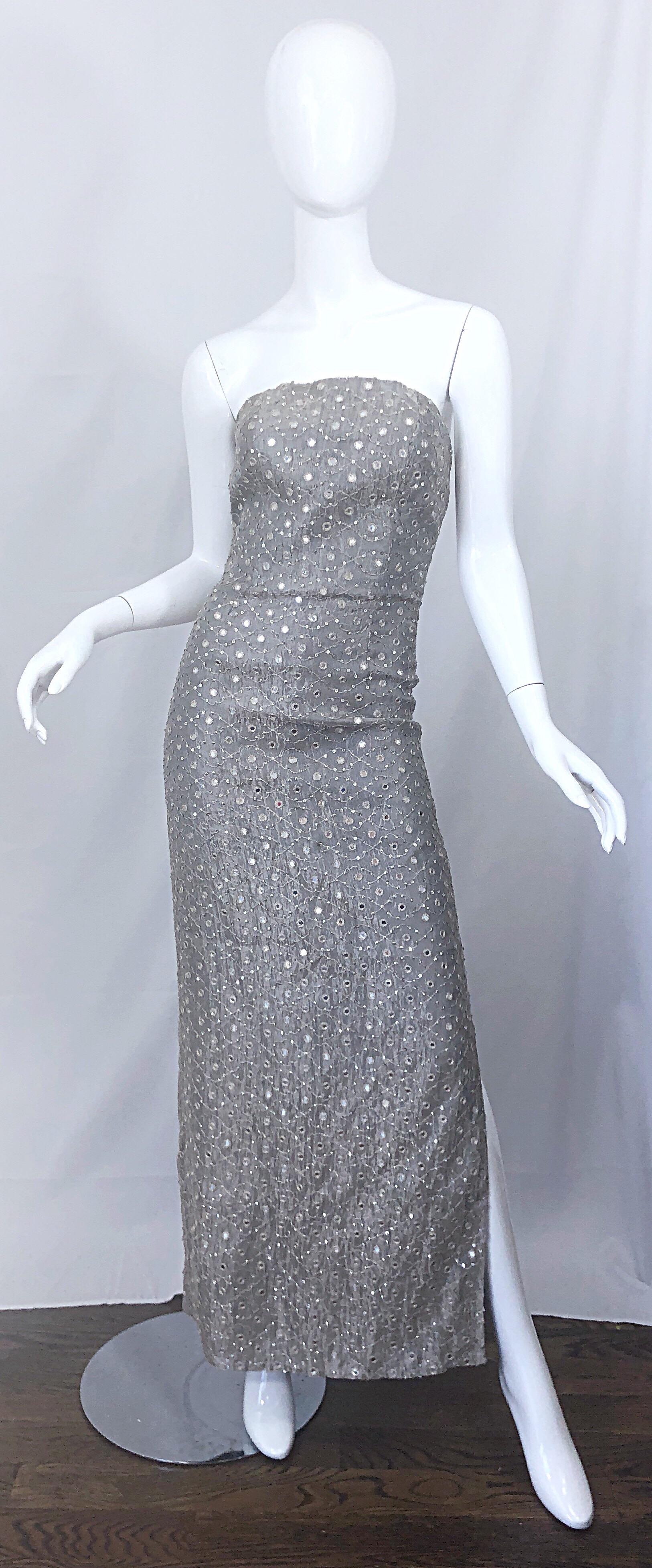 Beautiful vintage 1990s silver gray silk mirrored sequin couture strapless evening dress / gown! Features a fitted boned bodice, with a hidden zipper up the back and hook-and-eye closure. Slit up the left leg reveals just the right amount of skin. A