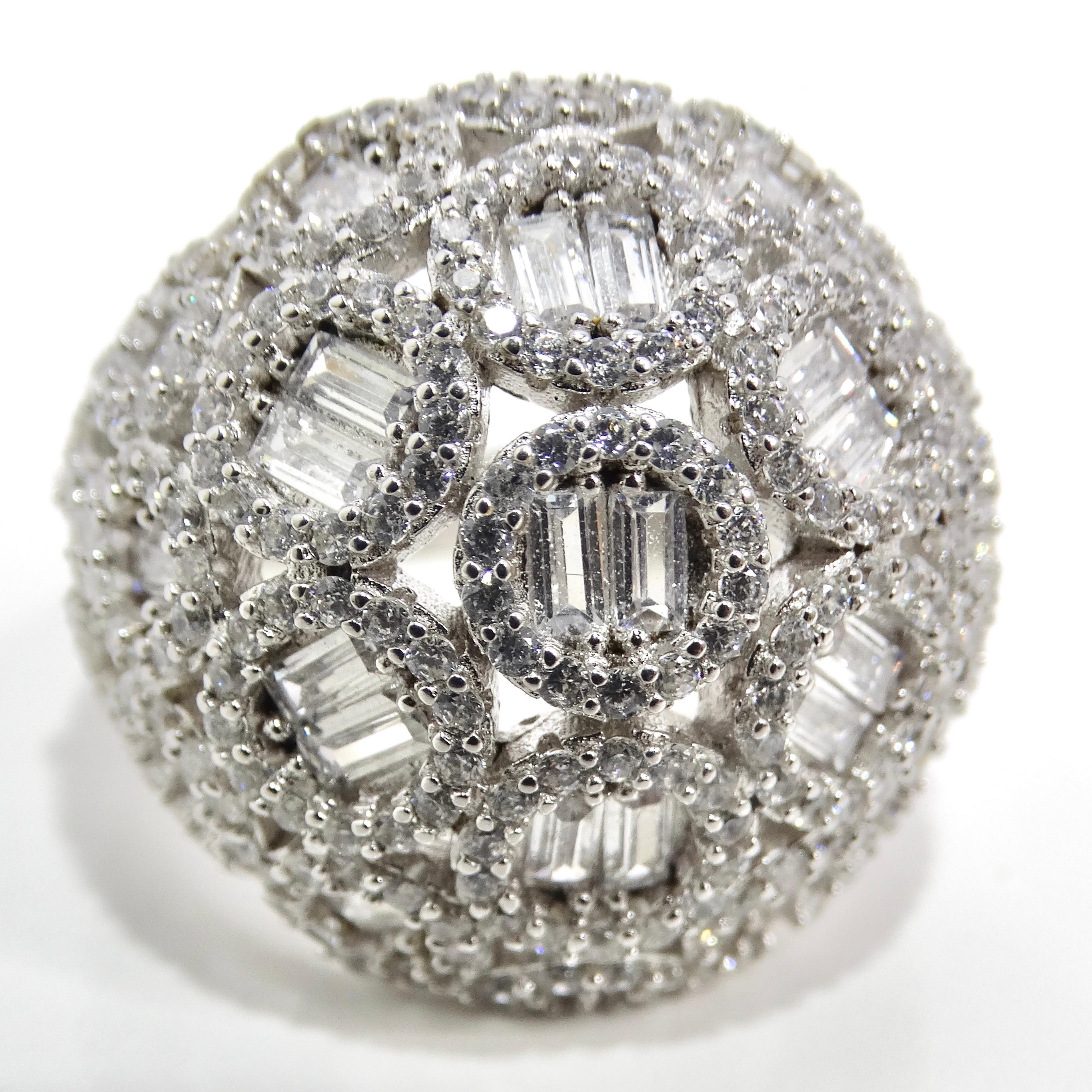 Indulge in the nostalgic allure of the 1990s with the mesmerizing 1990s Silver Swarovski Crystal Dome Ring. This exquisite piece of jewelry takes you on a journey back in time with its stunning design and timeless elegance. The ring features a