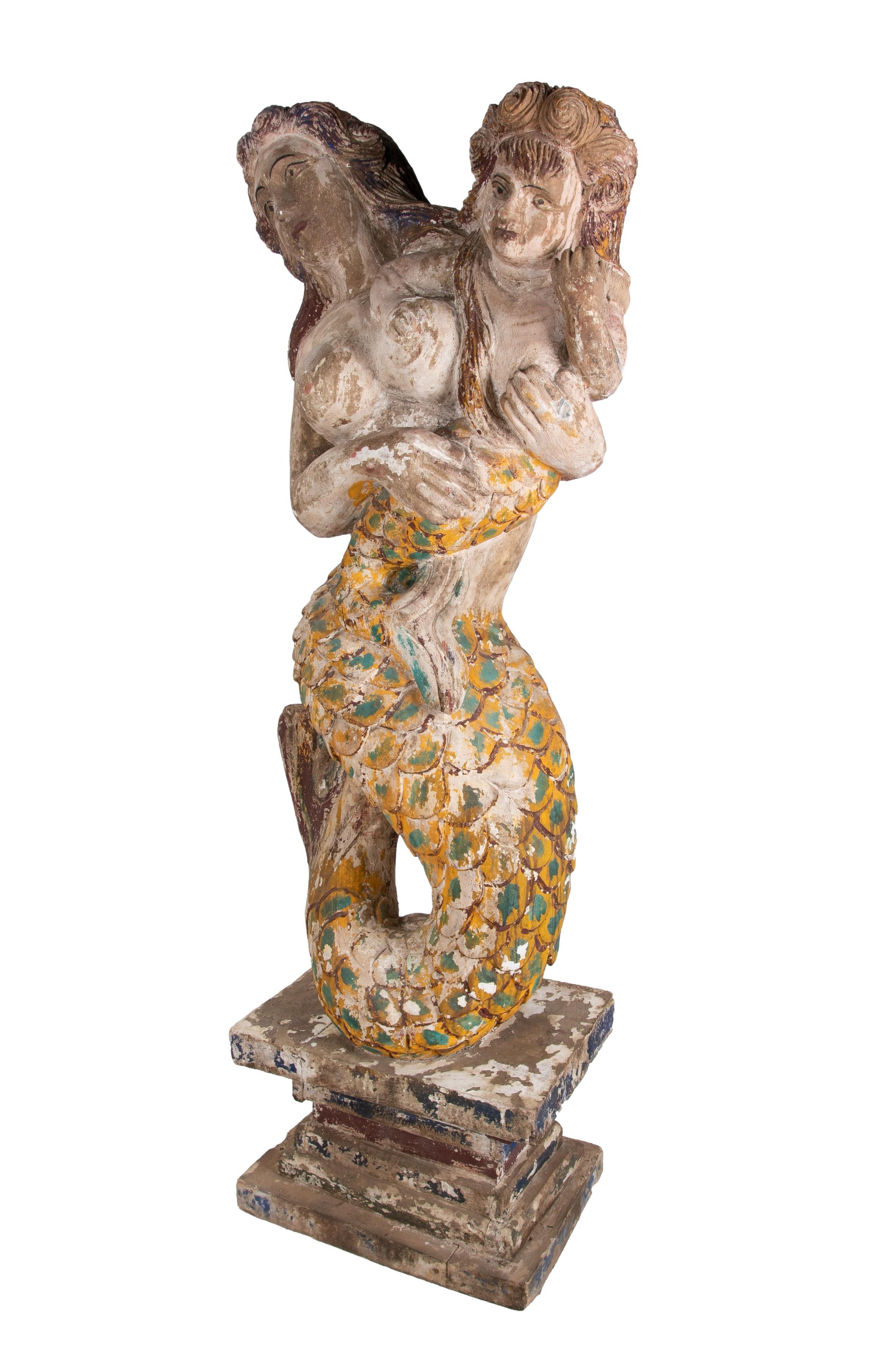 Vintage 1990s Spanish hand carved wooden painted mermaid with boy sculpture, reminiscent of a boats figurehead.