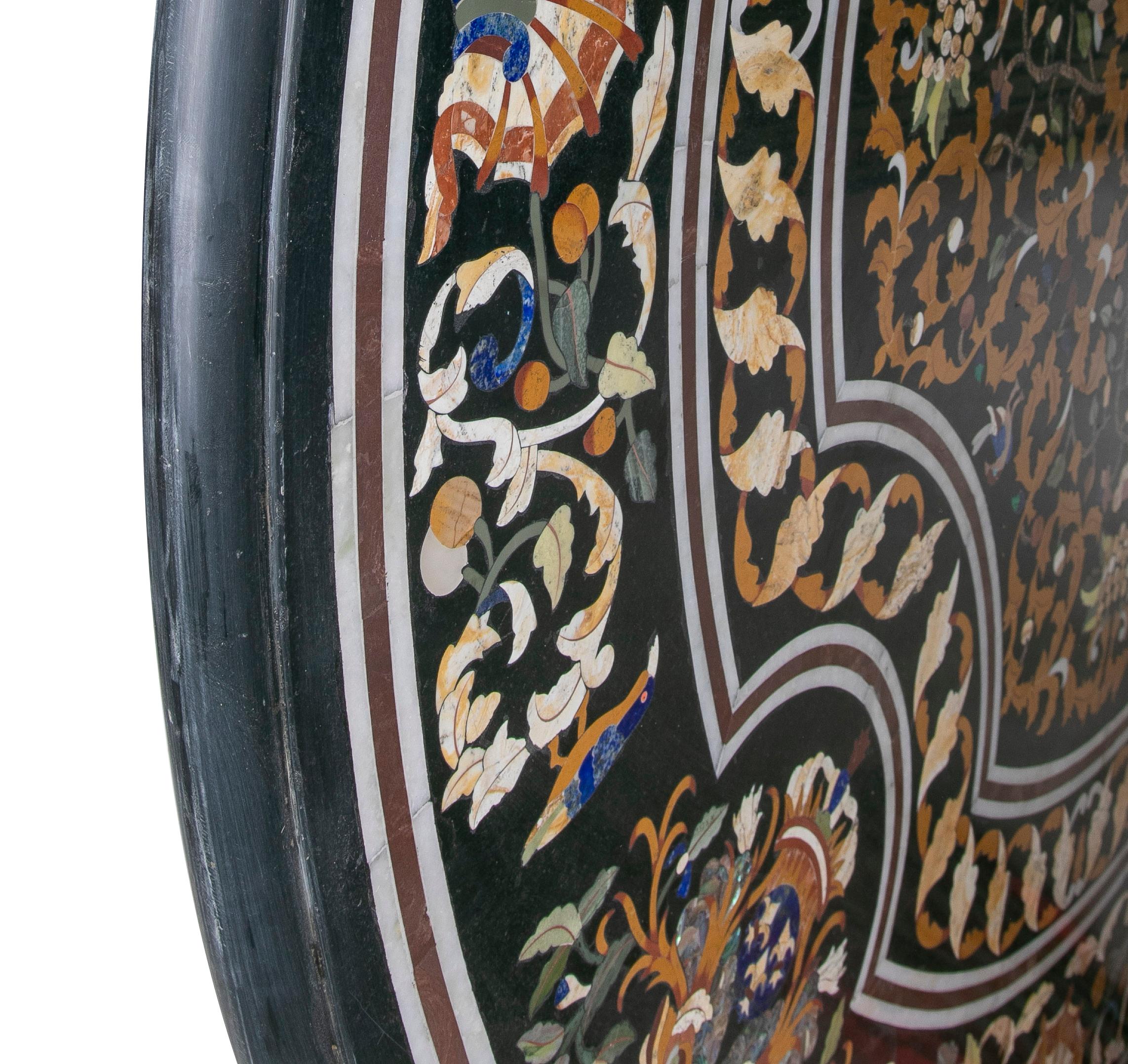 Classical Baroque 1990s Spanish handcrafted Pietra Dura mosaic inlay round black marble table top with lapis lazuli and an assortment of coloured marbles.