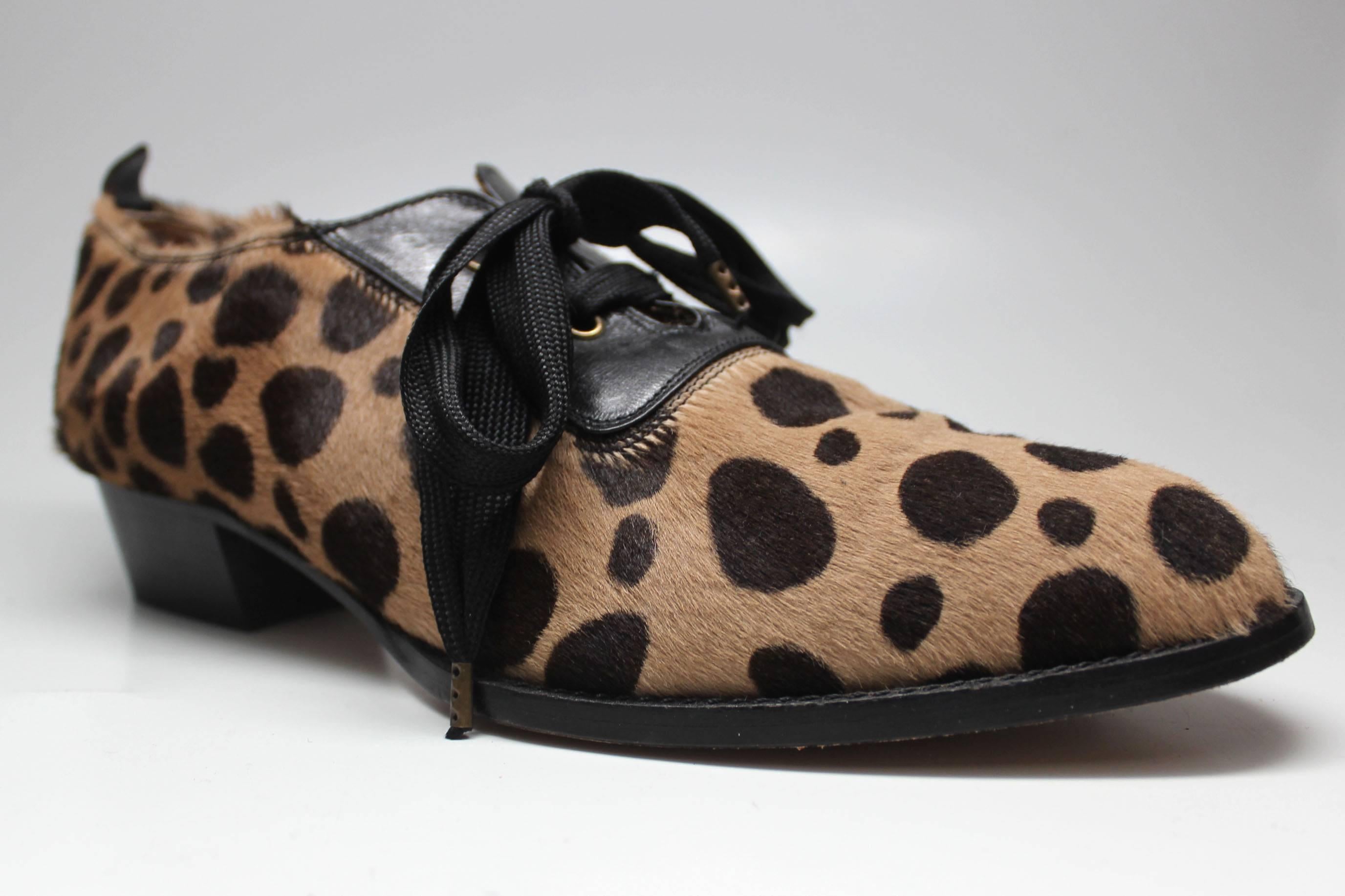 These luxe ponyskin oxfords are printed with leopard like spots. They are trimmed in black leather and have grosgrain laces.  They were made in Italy by the brand Mare in the 1990s.