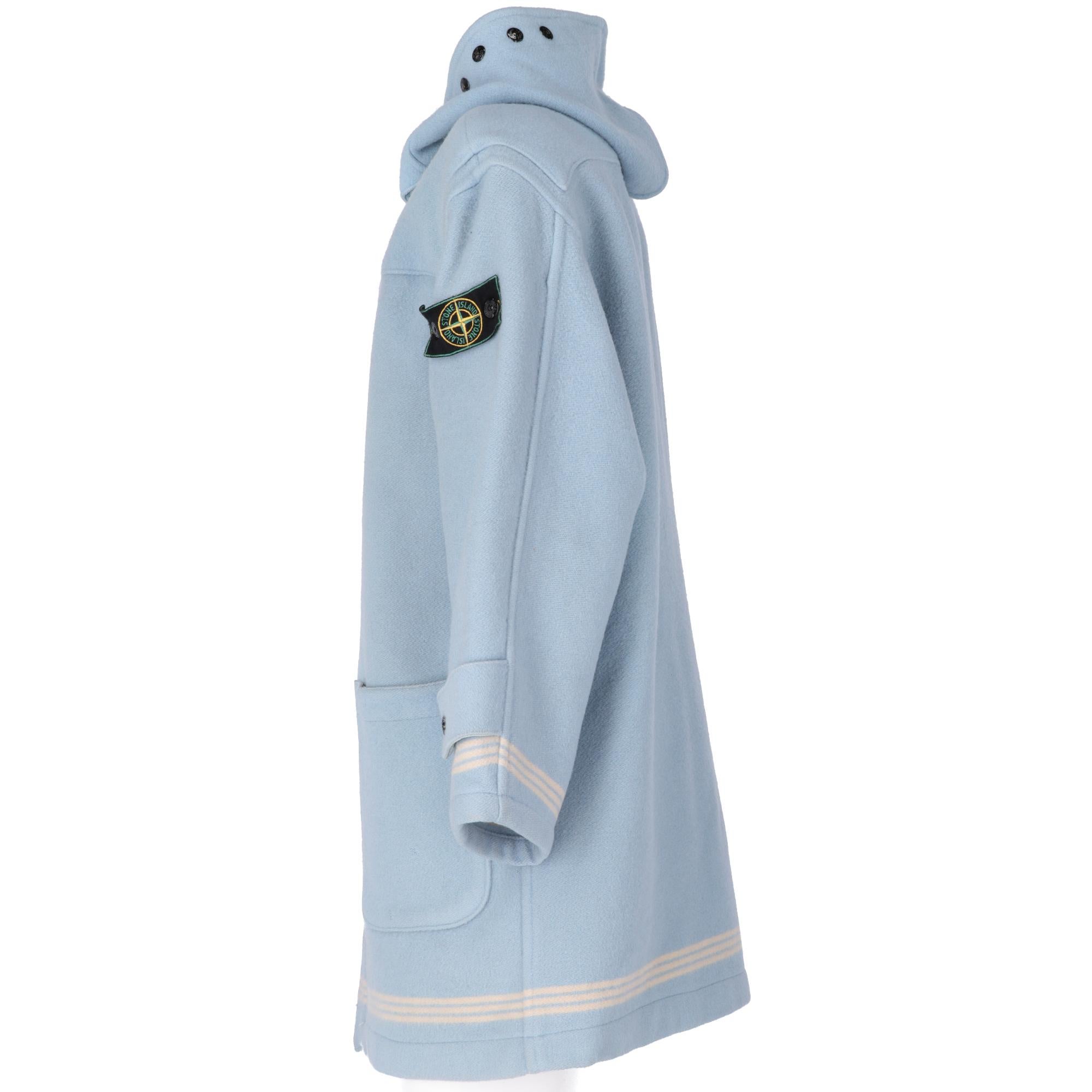 Stone Island light blue wool montgomery coat, with wooden frogs on the front,  hood decorated with press-studded buttons and cuffs with strap and button, a chinstrap and two front applied pockets, classic brand label on the left sleeve and three