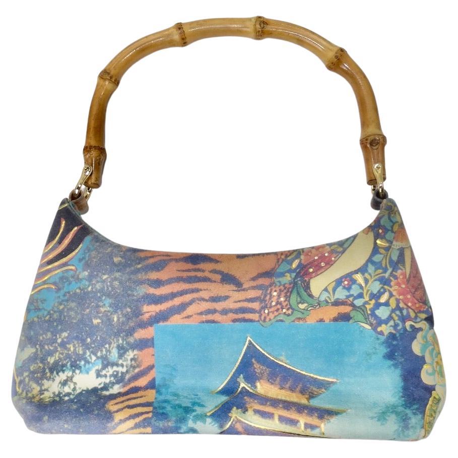 This 1990's dragon motif top handle handbag is the perfect way to spice up any outfit! The perfect size every day handbag in a printed suede featuring the most beautiful vibrant graphic of dragons on one side and Japanese landscapes on the other.