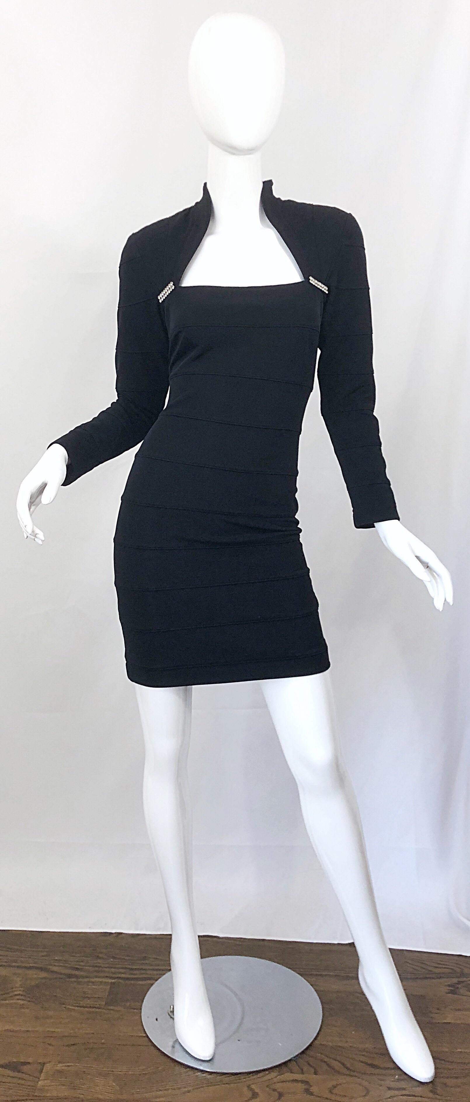 Sexy and classic mid 1990s TADASHI SHOJI black bodycon bandage mini dress! Features an avant garde style with an attached bolero style neck and sleeves. Rhinestone details at each side of the bust. Hidden zipper up the back with 
hook-and-eye