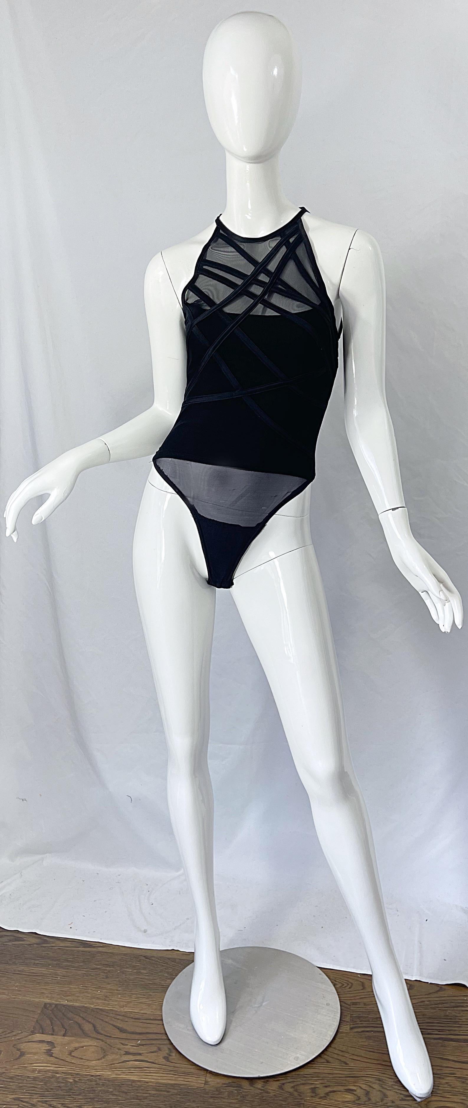 Sexy 1980s TADAShI SHOJI black bondage inspired bodysuit ! Features sheer mesh cut-out at top front and back. Soft rayon stretches to fit. Great with jeans, shorts, trosuers or a skirt. 
In great condition
Made in USA
Marked Size