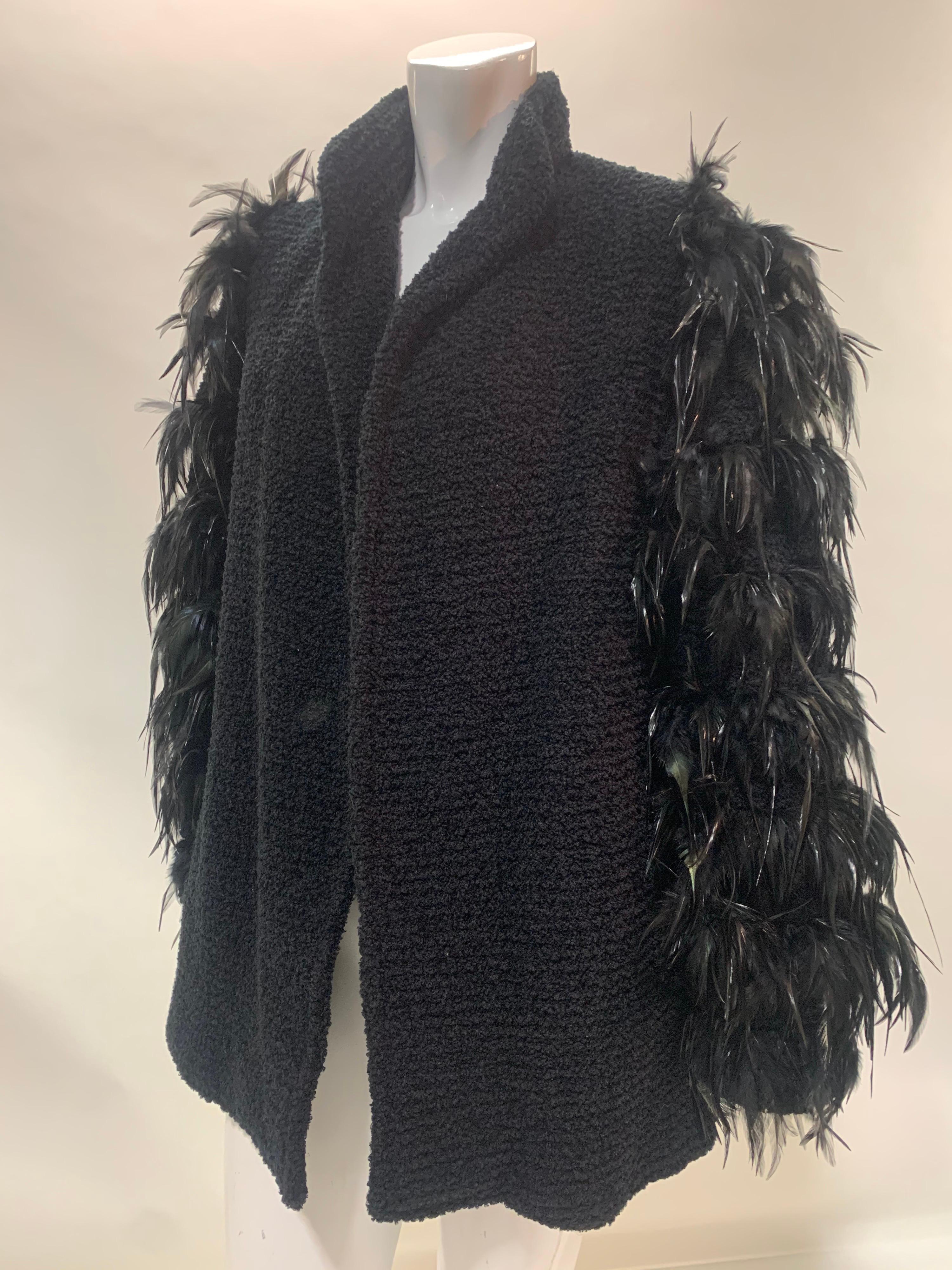 A darkly dramatic 1990s Ted Lapidus black wool boucle hip length coat with iridescent coq feather sleeves.  Open, no closure at front. Fully lined. Size EU 44.