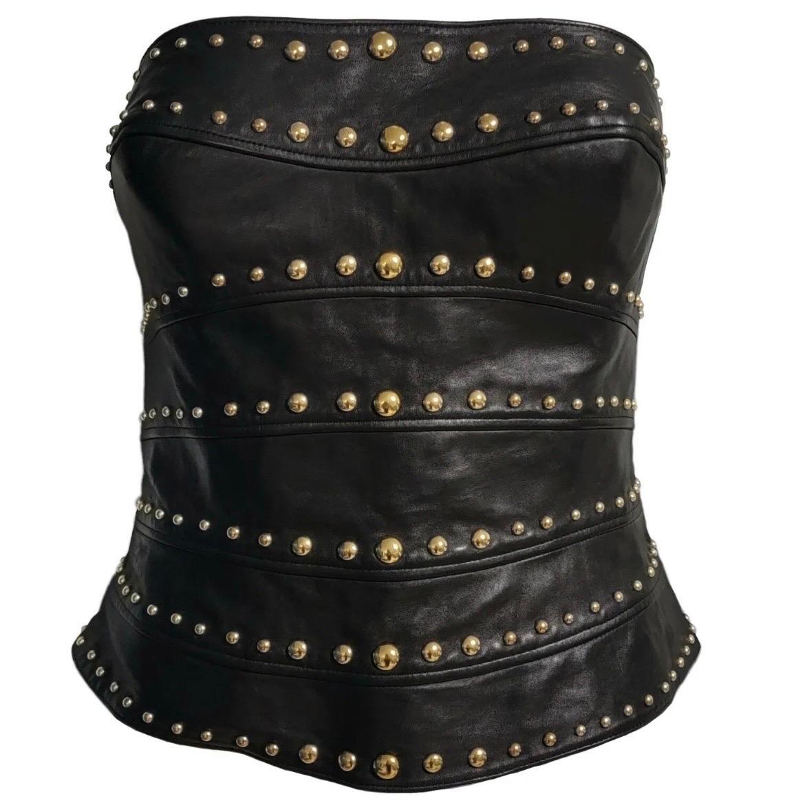 Incredible 1990's Thierry Mugler Couture strapless black leather studded bustier top.
The inside is lined and boned with a built in corset with cups to add shape and there is a fabric strap inside that goes around the waist for extra support.
Gold
