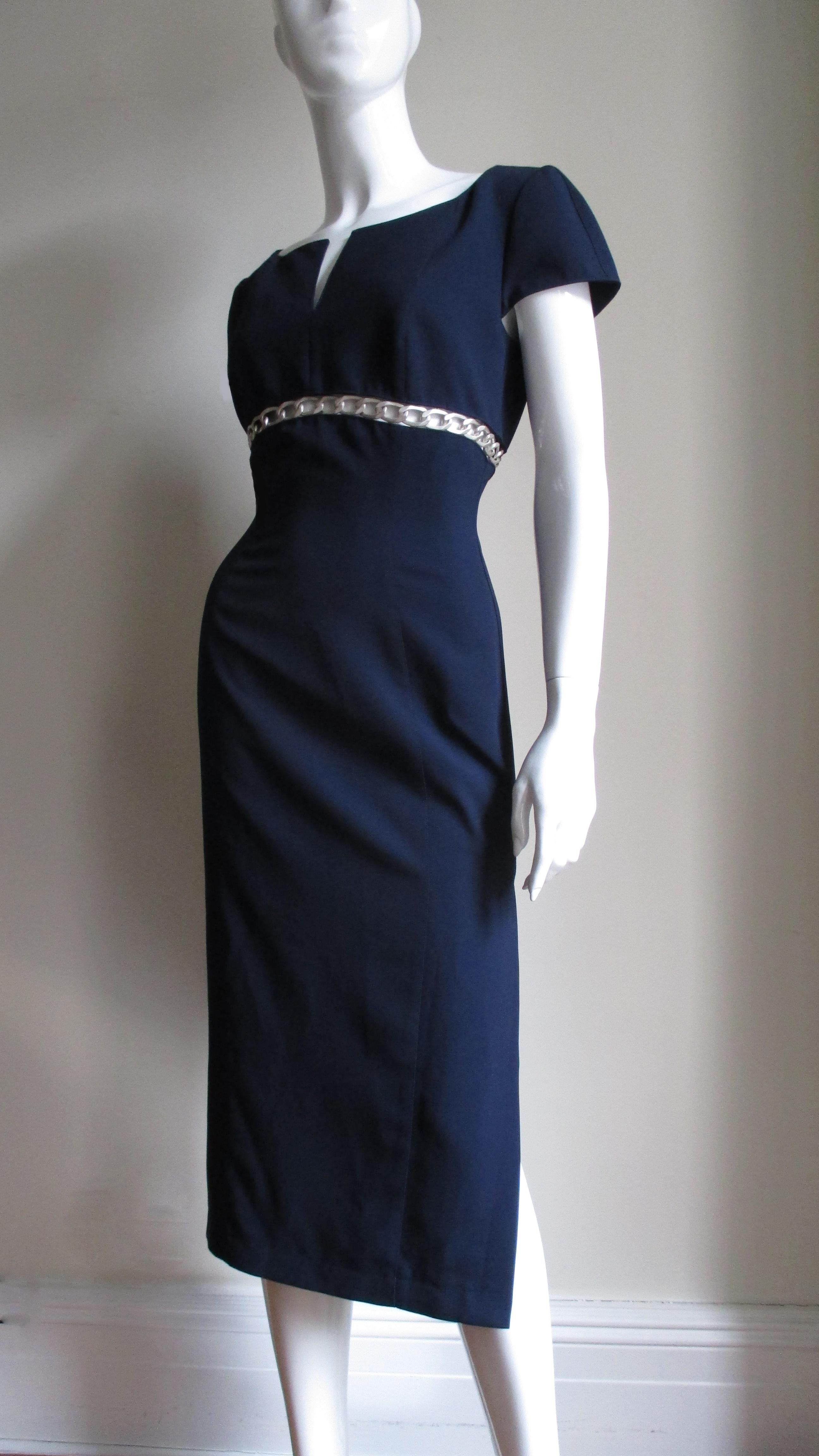 A fabulous navy blue dress from Thierry Mugler. It has a scoop neckline with a center slit, cap sleeves and an inset just under the bust line with a strip of 1