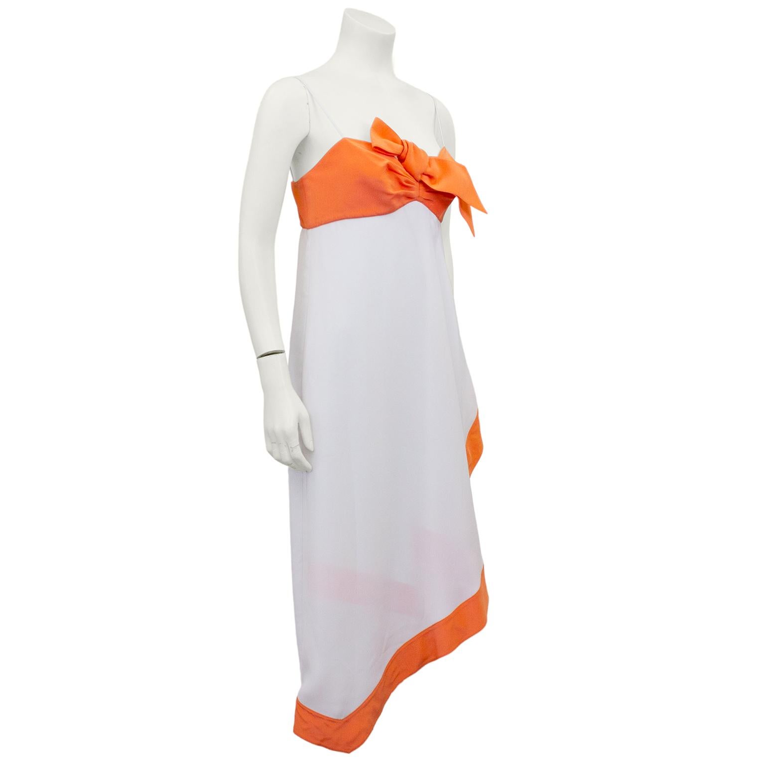 Thierry Mugler colour block silk cocktail dress from the 1990s. Orange bust with large bow. Empire waist with white diagonal cut hanky hem skirt with orange trim. Skirt is draped beautifully, in that iconic Mugler craftsmanship. Spaghetti straps.