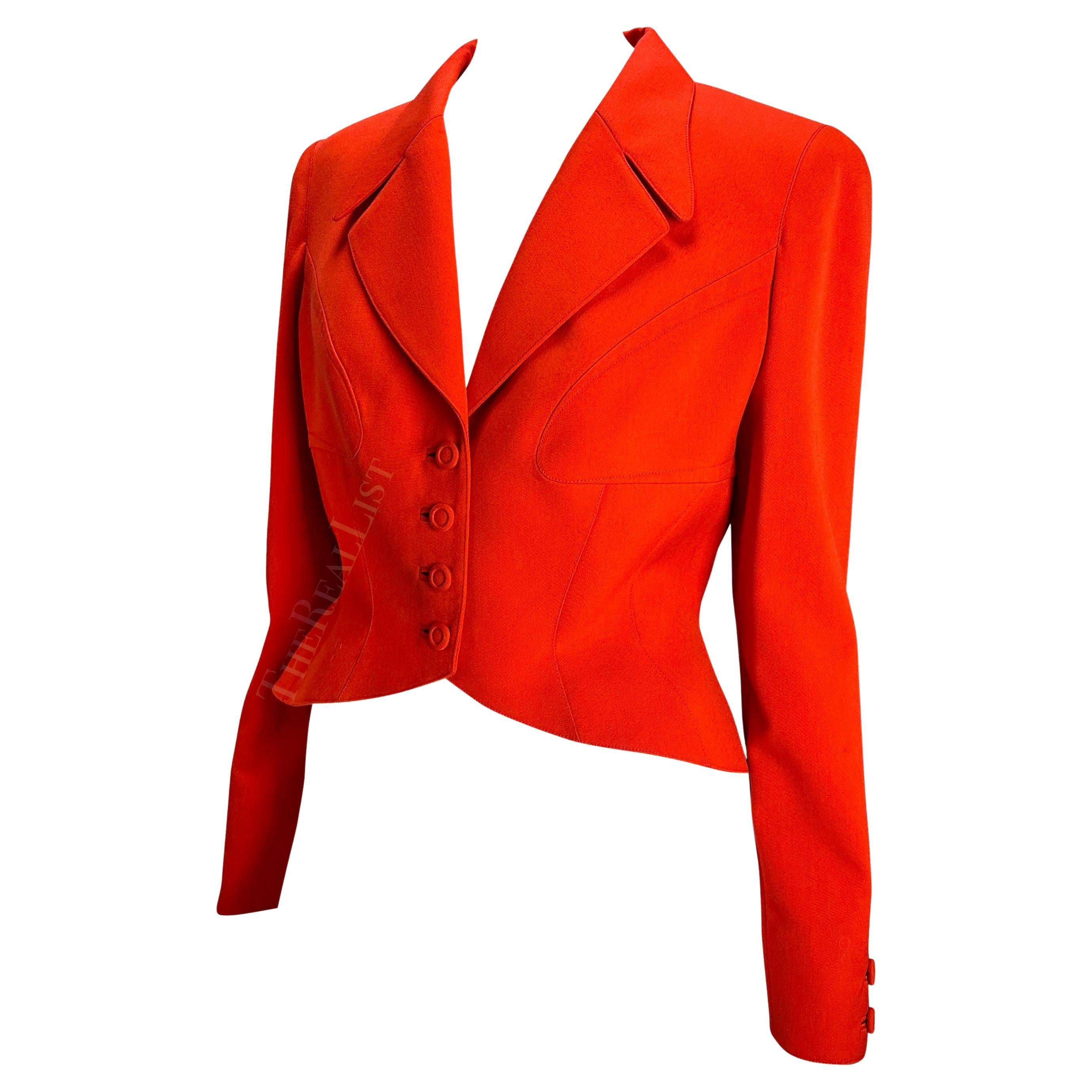 Presenting a fabulous bright orange Thierry Mugler blazer, designed by Manfred Mugler. From the 1980s, this jacket features masterful craftsmanship and design. Mugler was known for his exaggerated silhouettes with this jacket being no exception.
