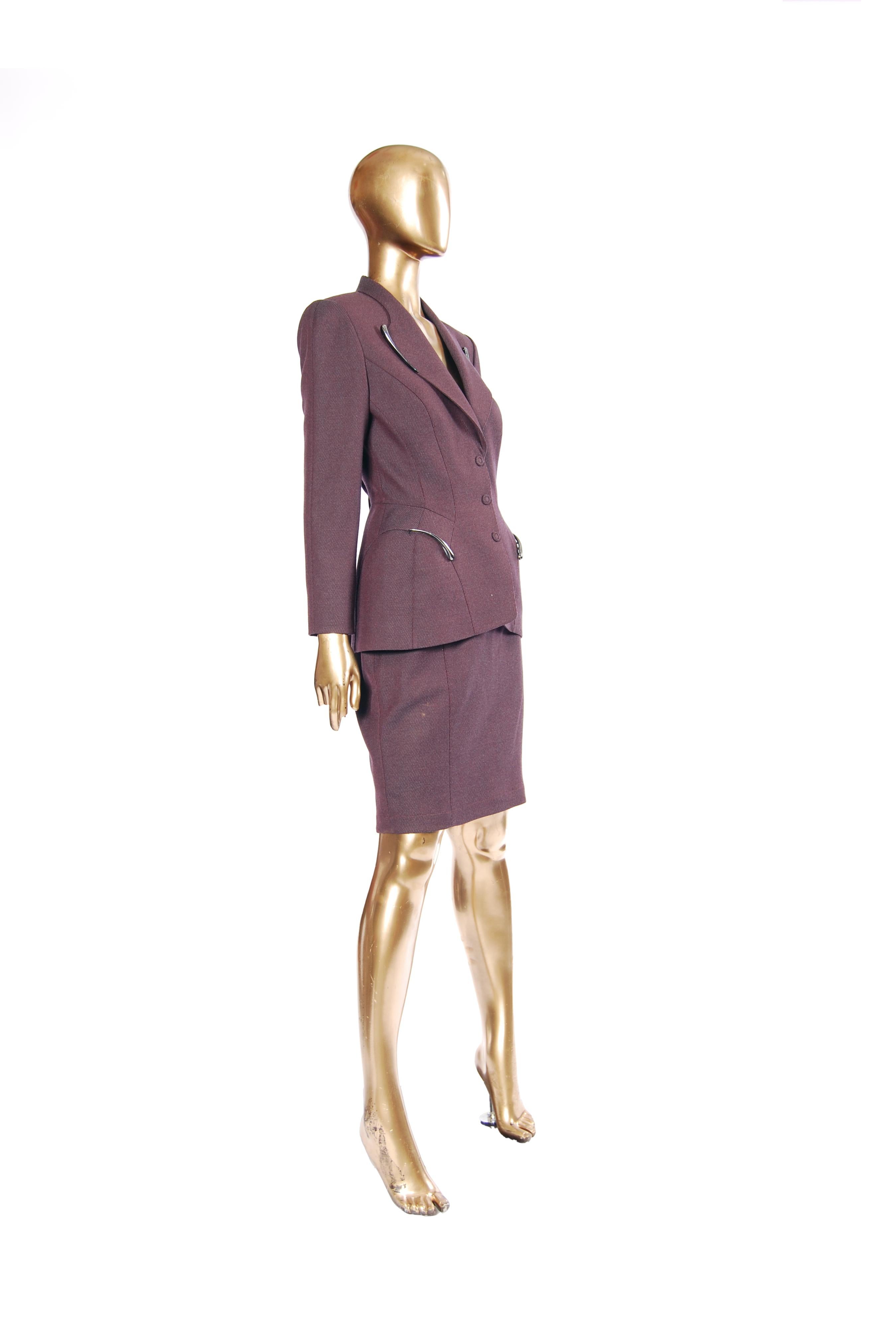A gorgeous example of Manfred Thierry Mugler’s visionary tailoring, this sculptural purple skirt suit debuted on the runway as part of the designer’s  Fall/Winter 1998 collection. The sharply tailored blazer showcases Mugler’s signature exaggerated